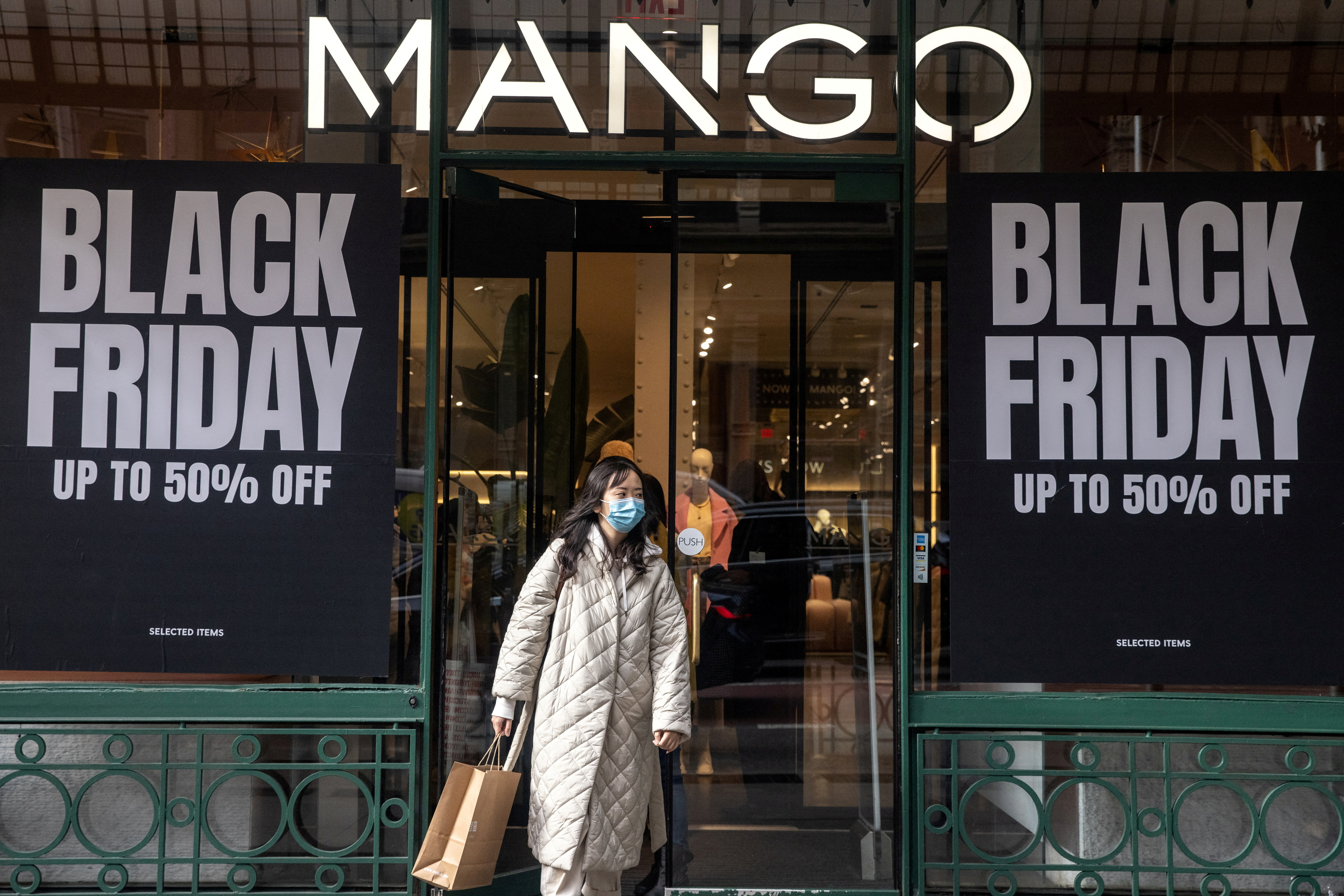 FILFOTO: En shopper går ut av en butikk under Black Friday-salget i bydelen Manhattan i New York City, New York, USA, 25. november 2021. REUTERS/Gena Moon/File Photo
