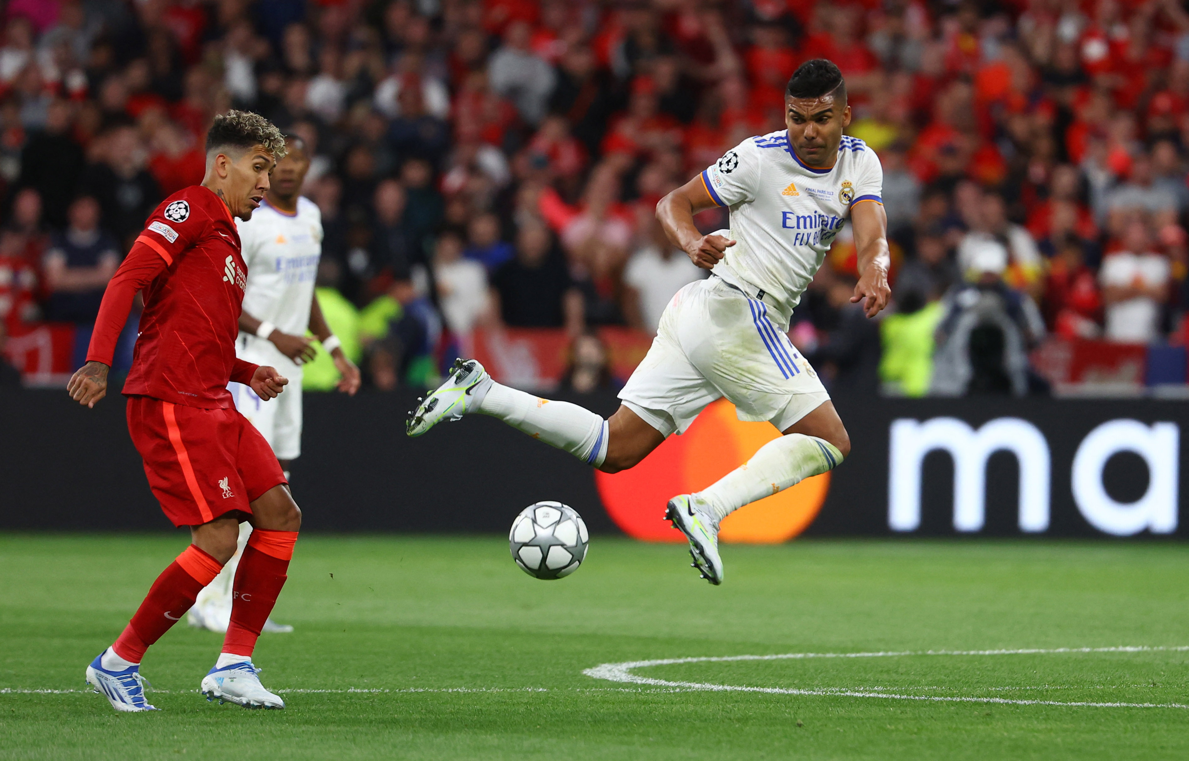 Soccer Football - Champions League Final - Liverpool v Real Madrid - Stade de France, Saint-Denis near Paris, France - May 28, 2022 Real Madrid's Casemiro in action with Liverpool's Roberto Firmino REUTERS/Kai Pfaffenbach