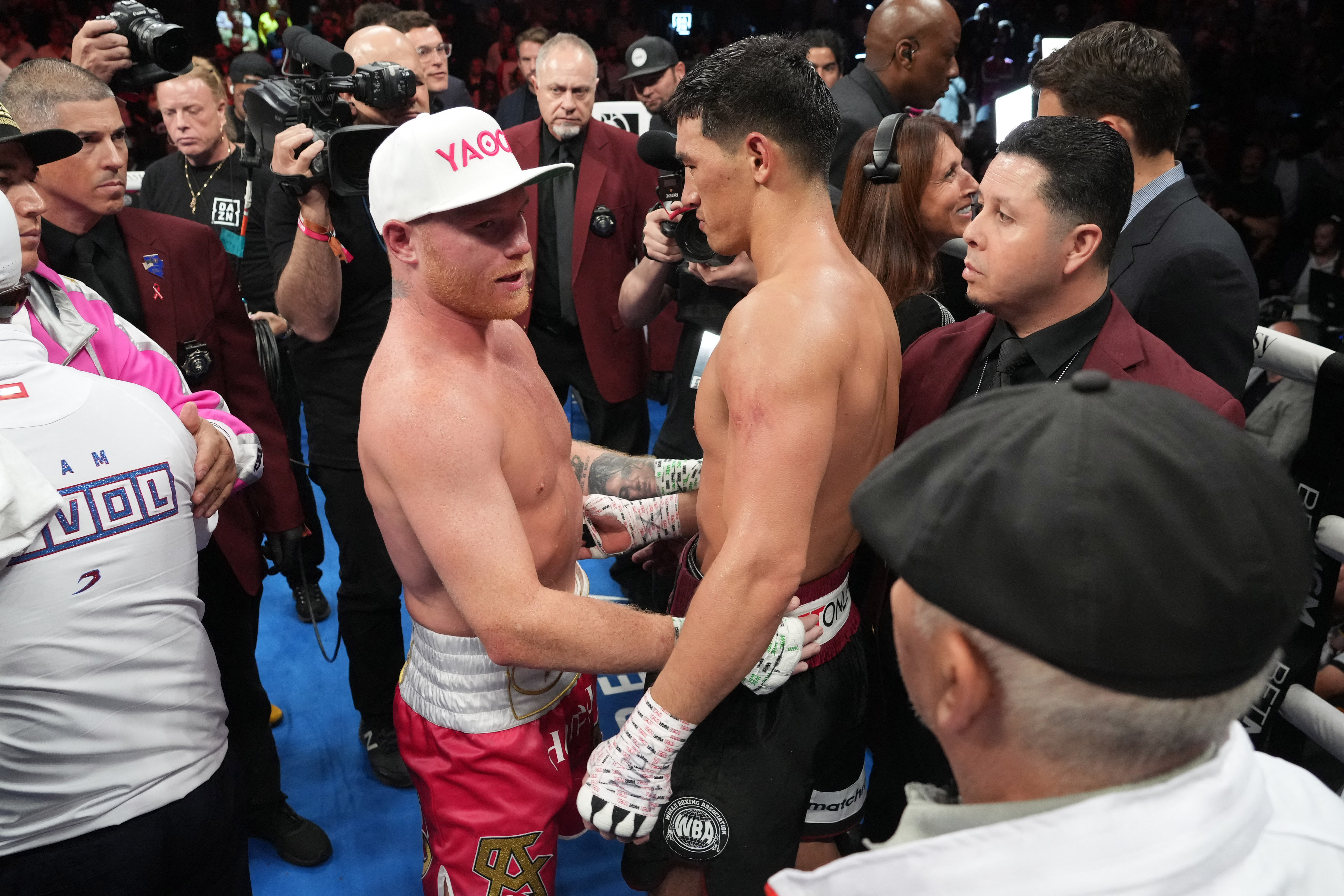 May 7, 2022; Las Vegas, Nevada, USA; Canelo Alvarez (pink trunks) and Dimitry Bivol (black trunks) embrace after their light heavyweight championship bout at T-Mobile Arena. Mandatory Credit: Joe Camporeale-USA TODAY Sports