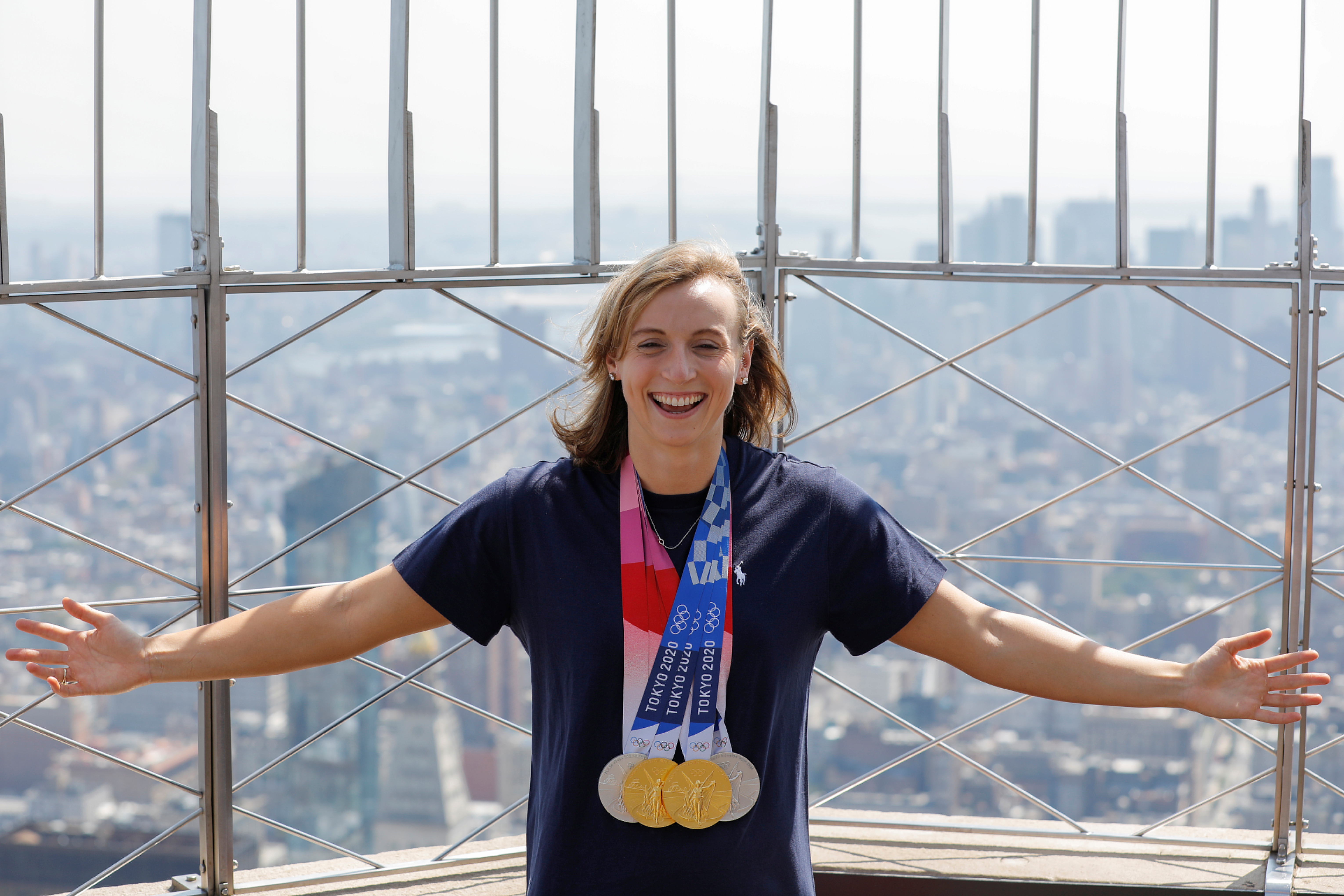 Tokyo 2020 Olympic Team USA swimming gold medalist Katie Ledecky poses as she stands on the observation deck of the Empire State Building in Manhattan, New York City, U.S., August 12, 2021. REUTERS/Andrew Kelly