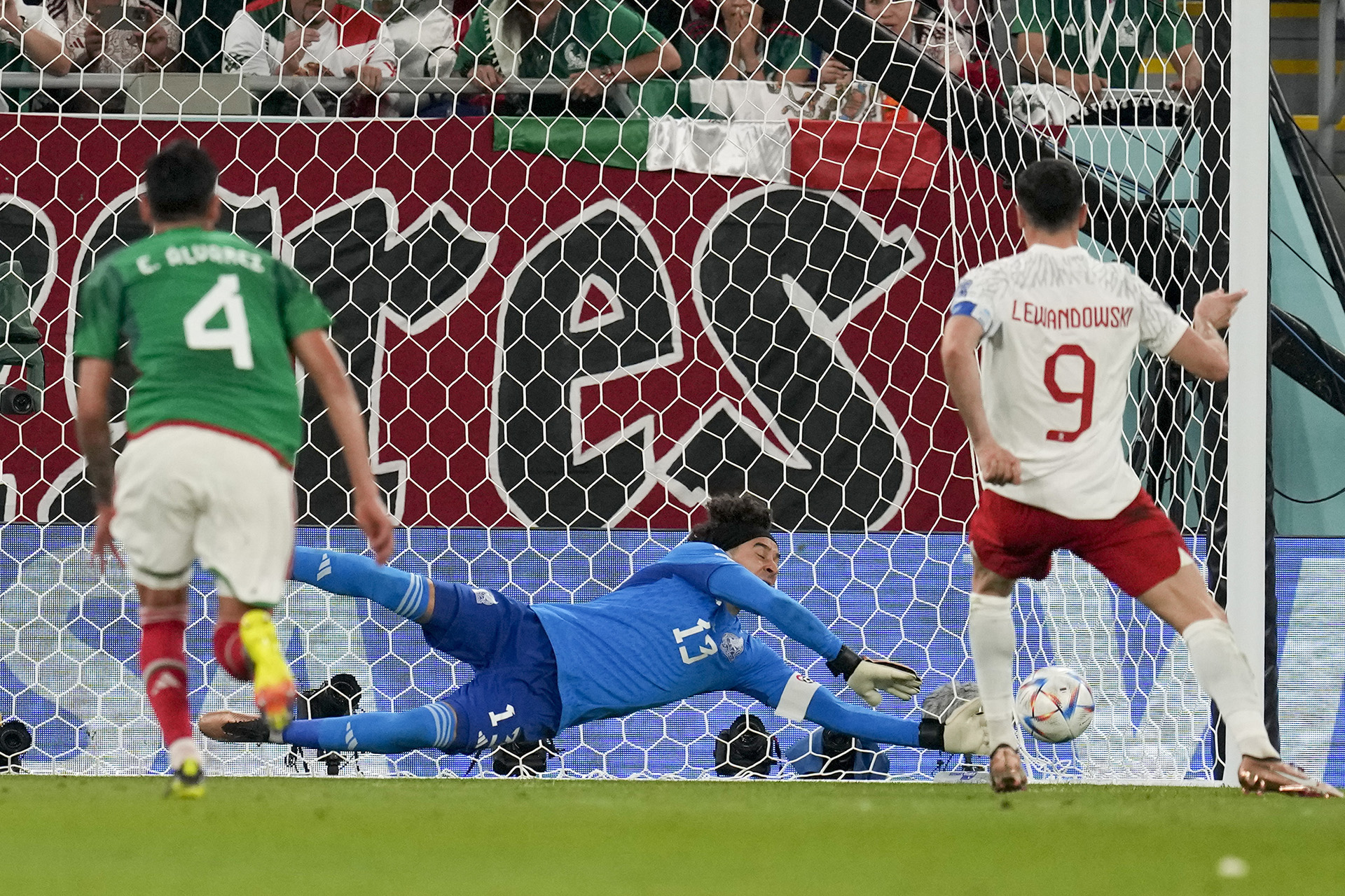 Mexico goalkeeper Guillermo Ochoa saves the penalty taken by Poland's Robert Lewandowski in the World Cup Group C match, Tuesday, November 22, 2022, in Doha, Qatar.  (AP Photo/Themba Hadebe)
