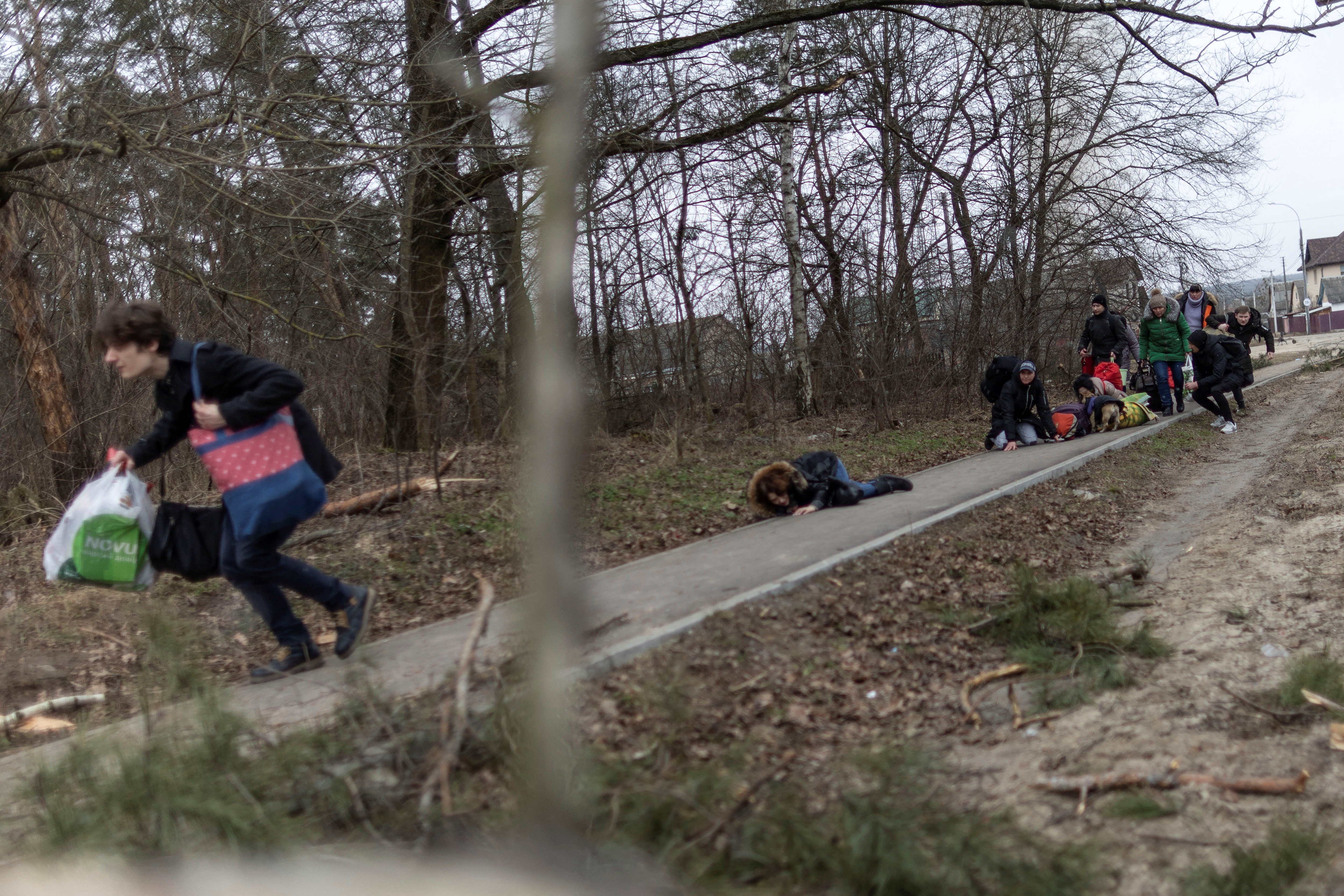 Civiles ucranianos hacen cuerpo a tierra para intentar protegerse de la embestida rusa en Irpin