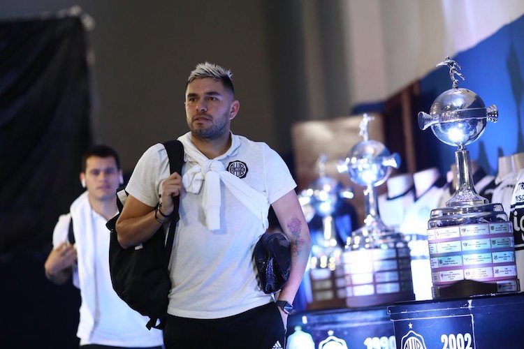 Así iban pasando los peloteros de Olimpia en lo que fue su llegada al Defensores del Chaco, posando entre las copas.