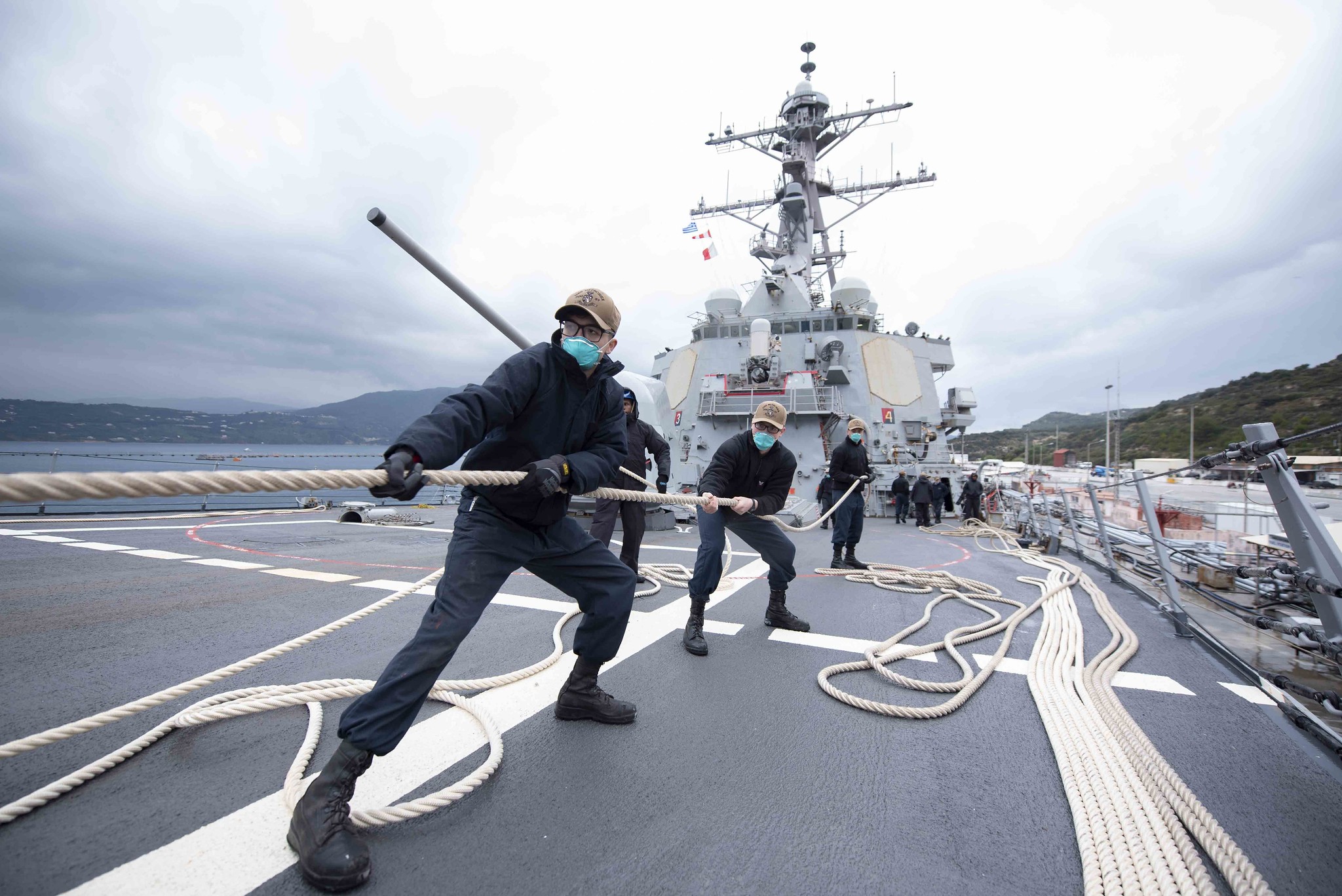 Sailors heave in line as the Arleigh Burke-class guided-missile destroyer USS Mitscher (DDG 57) prepares to depart Souda Bay, Greece, March 24, 2021. (MC2 Kaleb J. Sarten/Navy)