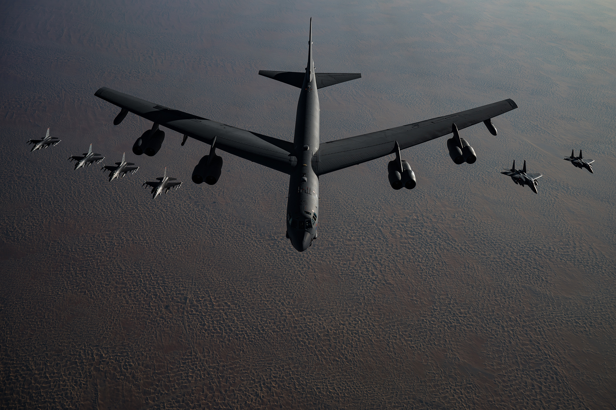 A B-52 Stratofortress flies in formation with F-16 Fighting Falcons and F-15E Strike Eagles during a Bomber Task Force mission over the U.S. Central Command area of responsibility, Nov. 21, 2020. (Staff Sgt. Sean Carnes/Air Force)