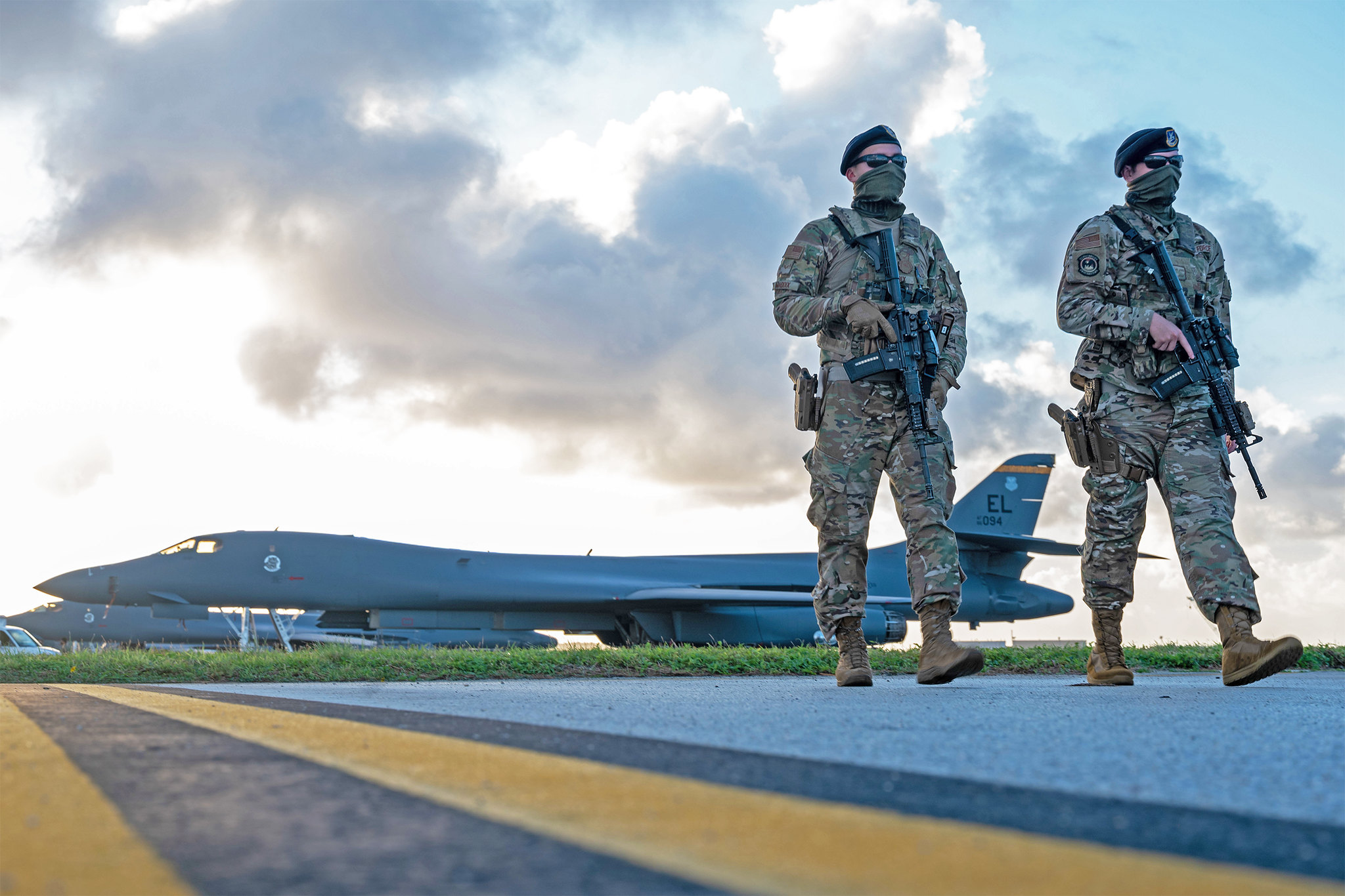 Security forces airmen patrol near a U.S. Air Force B-1B Lancer taxiway at Andersen Air Force Base, Guam, in support of a Bomber Task Force mission, Dec. 26, 2020. (Senior Airman Tristan Day/Air Force)