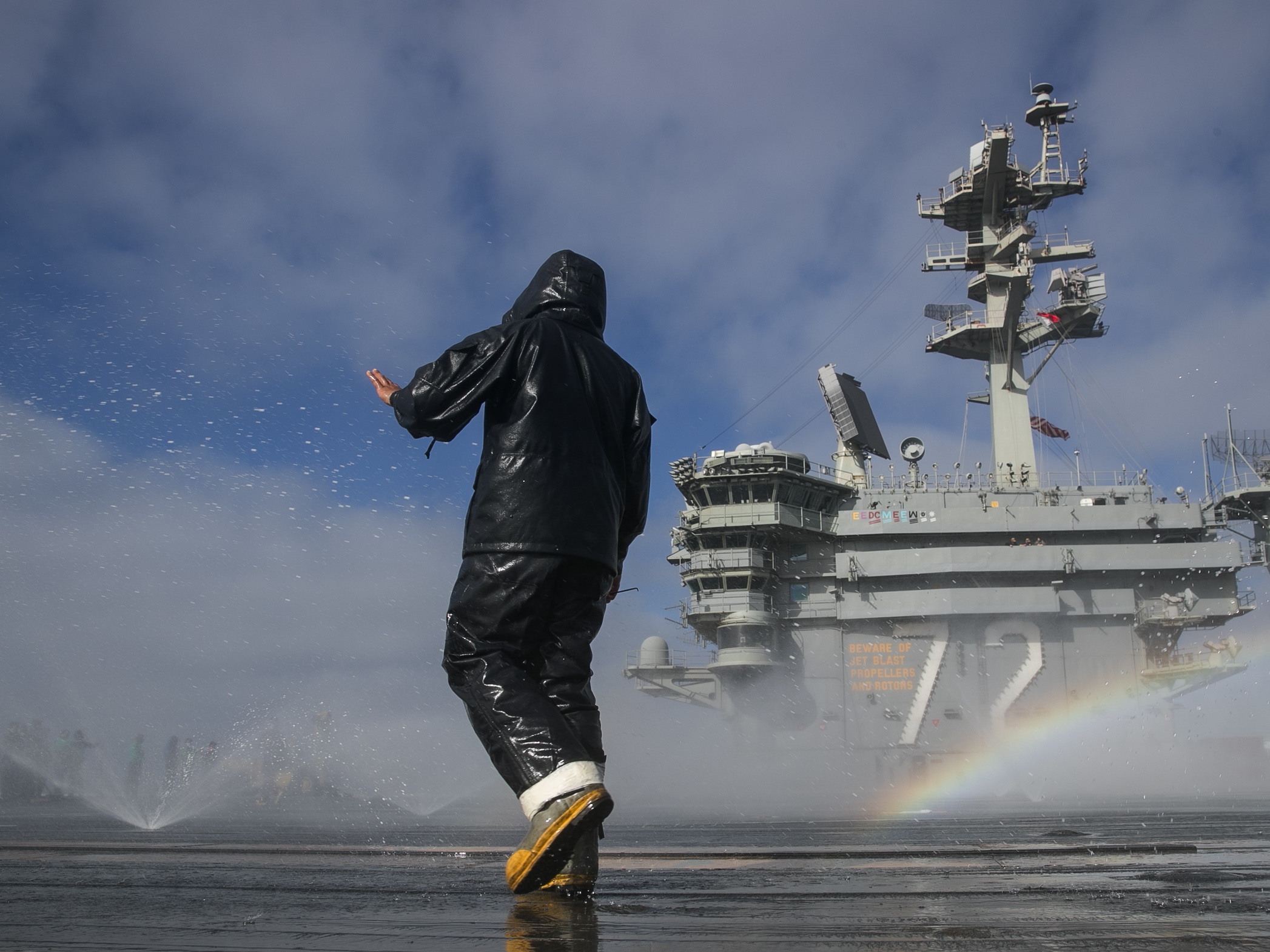 Aviation Boatswain's Mate (Handling) Airman Michael Meneses inspects the flight deck's countermeasure wash-down sprinklers on the aircraft carrier USS Abraham Lincoln (CVN 72) on May 16, 2020, in the Pacific Ocean. (Mass Communication Specialist Seaman Apprentice Javier Reyes/Navy)