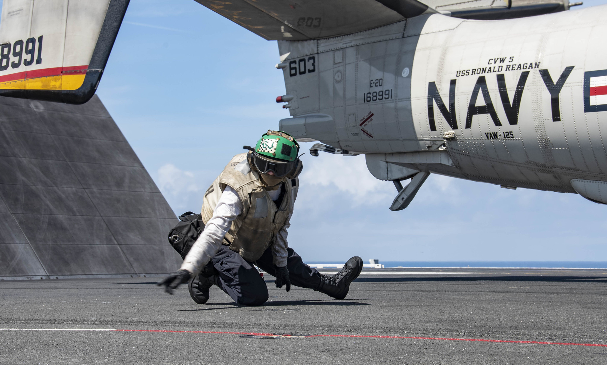 Aviation Machinist’s Mate 3rd Class Brandee Robinson conducts final checks on an E-2D Hawkeye as it prepares to launch from the flight deck of the aircraft carrier USS Ronald Reagan (CVN 76) on Aug. 2, 2020, in the Pacific Ocean. (MC3 Erica Bechard/Navy)