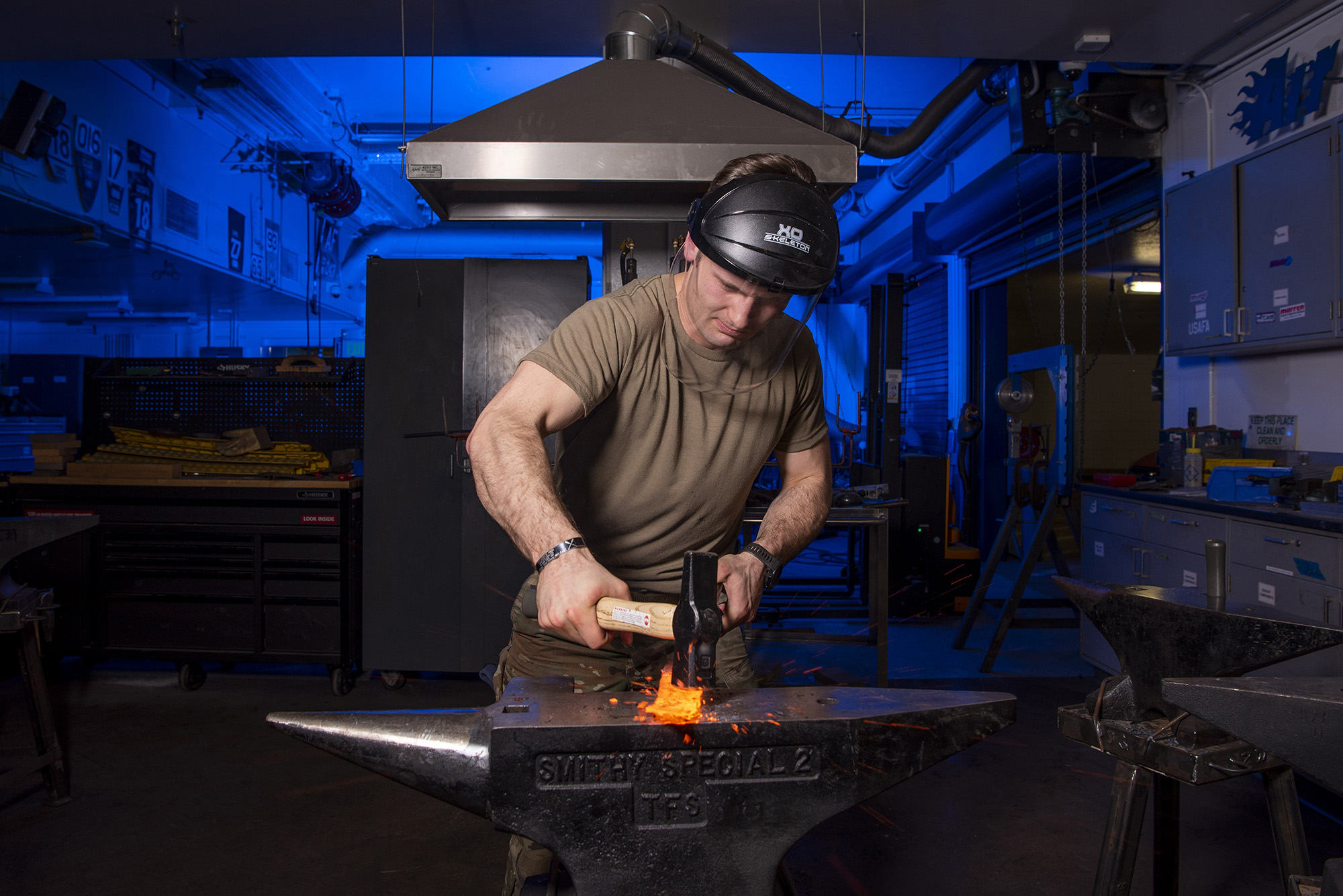 Cadet 1st Class Isaac Perkins shapes a piece of hot steel into a knife as part of the physical metallurgy class in the Air Force Academy’s mechanical engineering metal fabrication laboratory, Feb. 17, 2021. (Joshua Armstrong/Air Force)