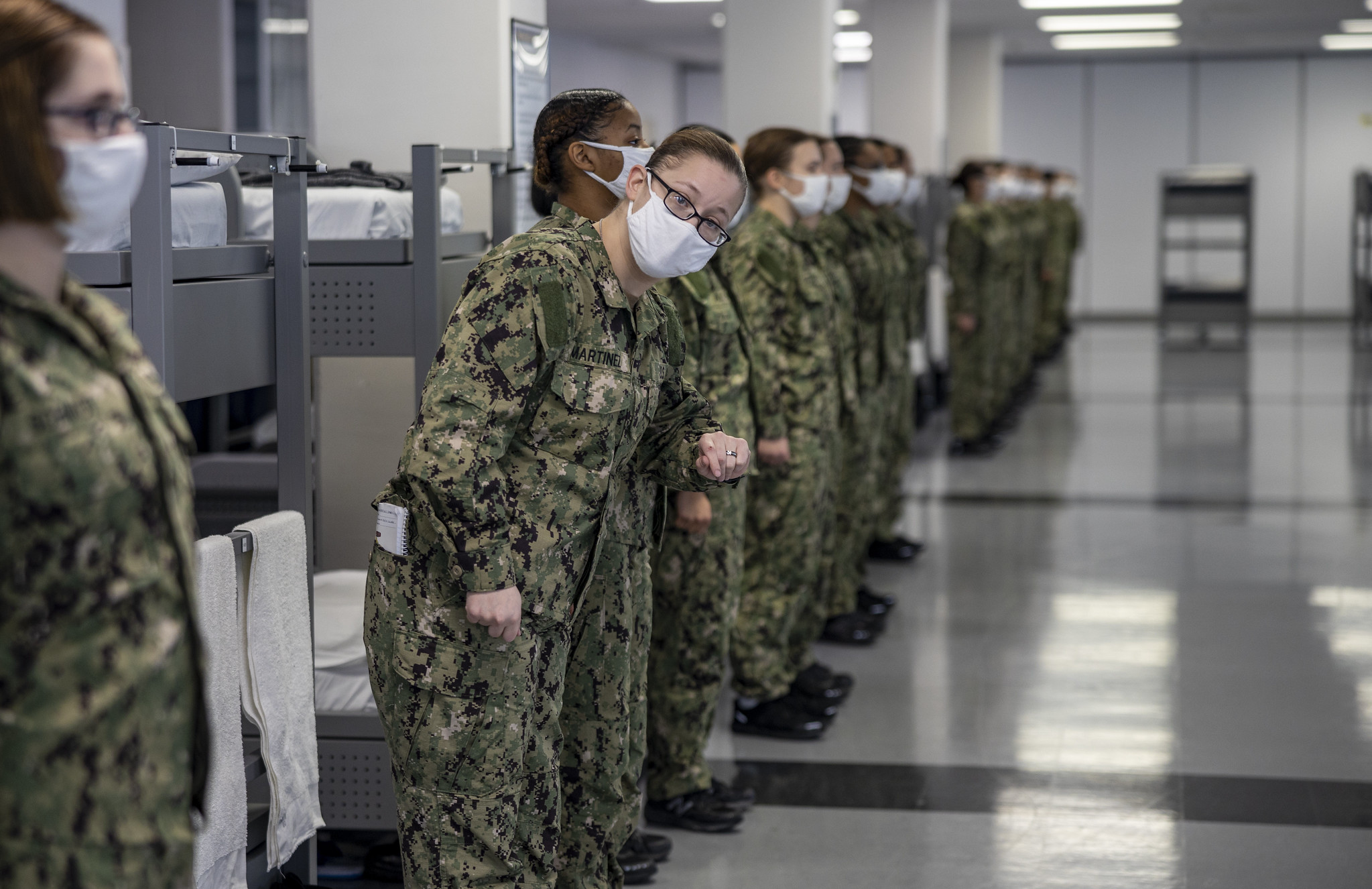 Seaman recruit Shanda Martinez, a recruit chief petty officer, checks to see if her division is ready for their first task during a dynamic material inspection Dec. 21, 2020, at Recruit Training Command at Great Lakes, Ill. (MC1 Camilo Fernan/Navy)