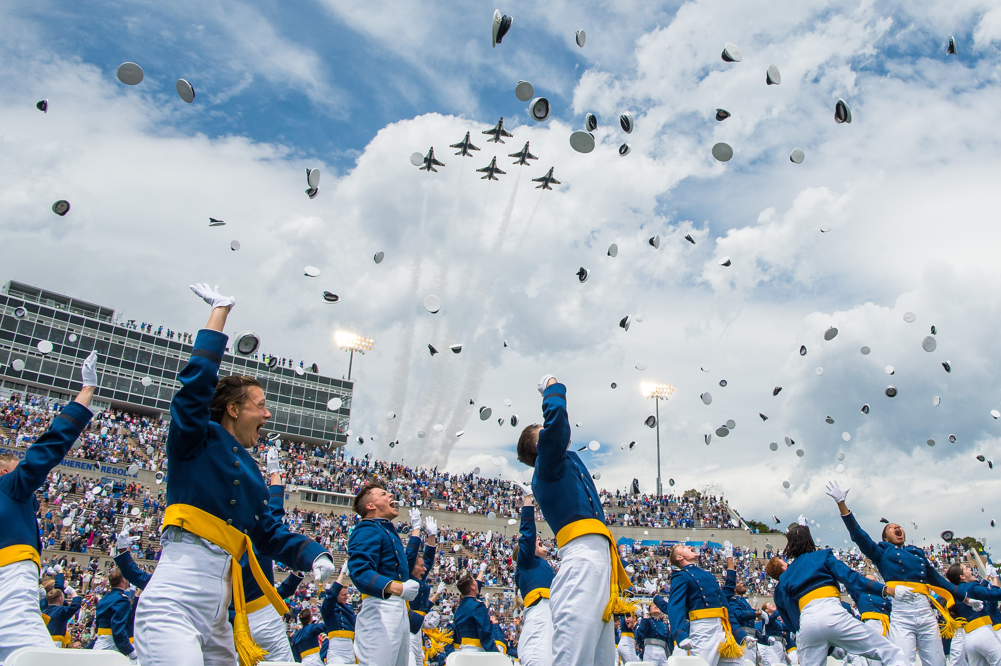 The U.S. Air Force Academy Class of 2021 graduates toss their hats skyward as the U.S. Air Force Thunderbirds roar overhead during the graduation ceremony in Colorado Springs, Colo., May 26, 2021. One-thousand-nineteen cadets crossed the stage to become the Air Force/Space Force’s newest second lieutenants. (Trevor Cokley/Air Force)