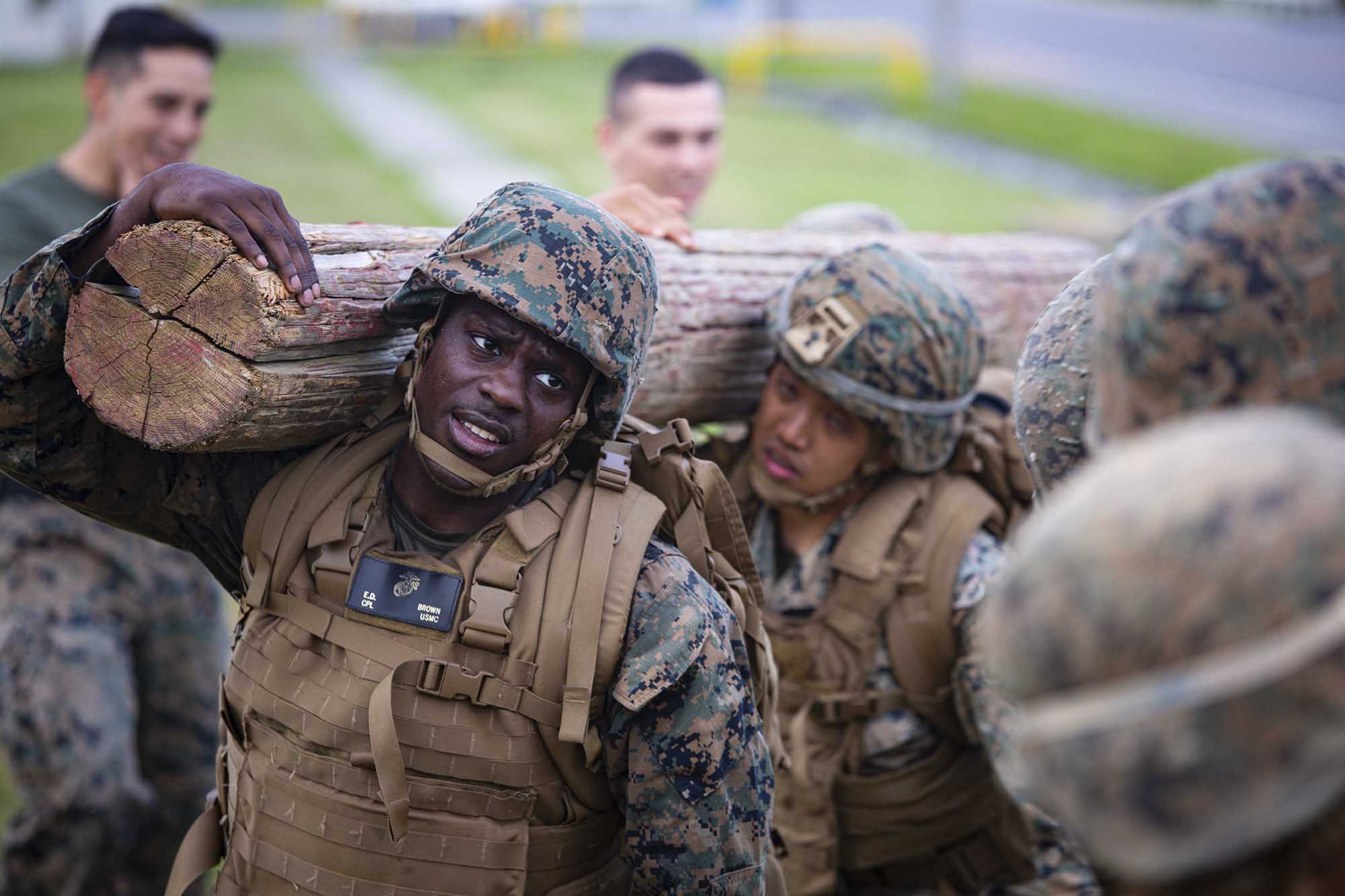 Cpl. Elbert Brown carries a log during the culminating event of the Marine Corps Martial Arts Program Instructor Course April 9, 202, on Marine Corps Air Station Futenma, Okinawa, Japan. (Staff Sgt. Lucas Vega/Marine Corps)