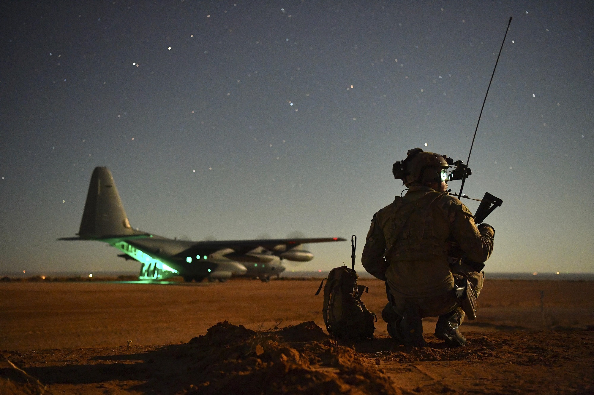 A Special Tactics operator guides a 27th Special Operations Wing MC-130J onto a runway during an exercise Nov. 6, 2020, at Melrose Air Force Range, N.M. (Staff Sgt. Ridge Shan/Air Force)