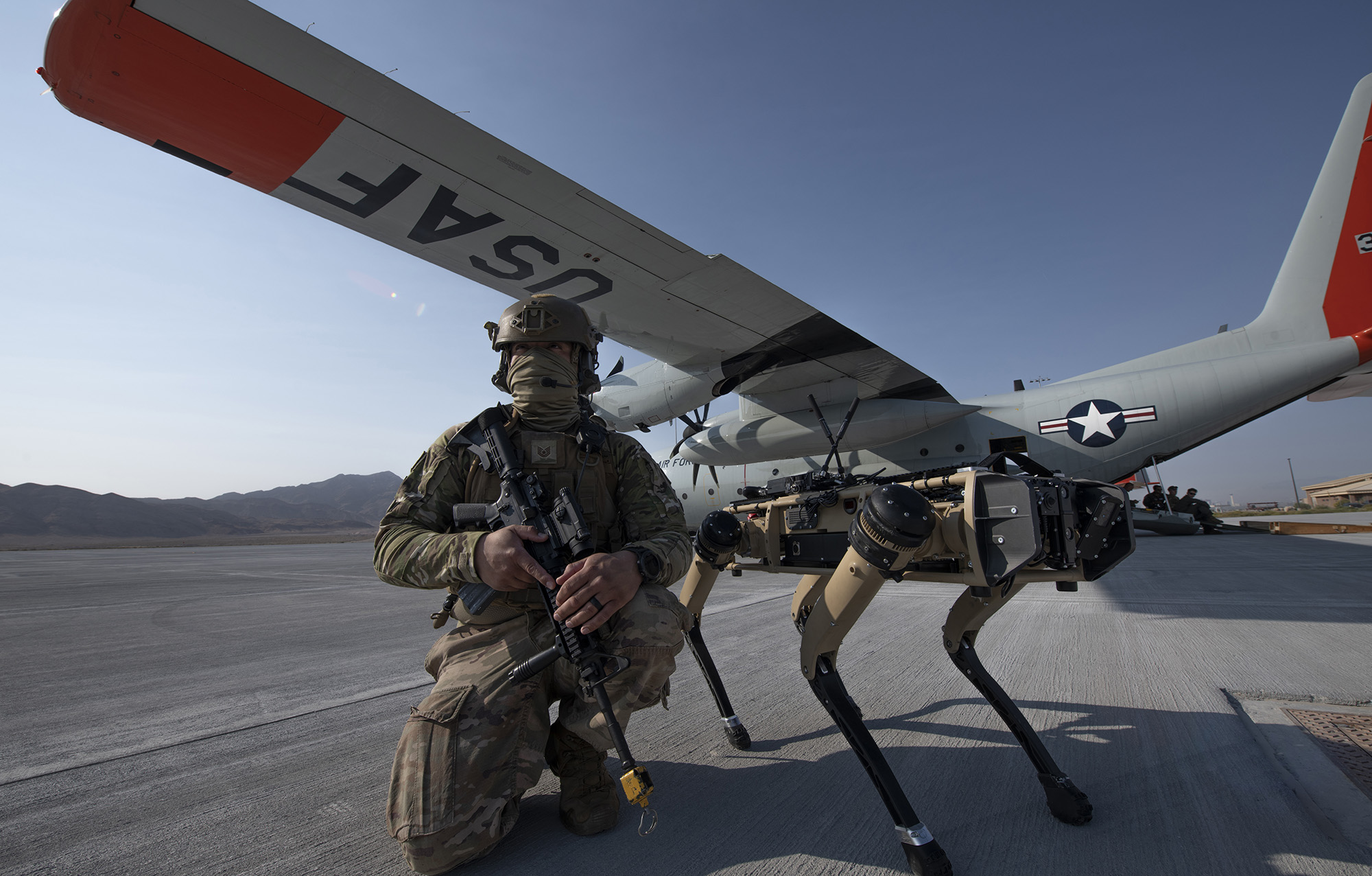 Tech. Sgt. John Rodiguez provides security with a Ghost Robotics Vision 60 prototype at a simulated austere base during the Advanced Battle Management System exercise on Nellis Air Force Base, Nev., Sept. 1, 2020. (Tech. Sgt. Cory D. Payne/Air Force)