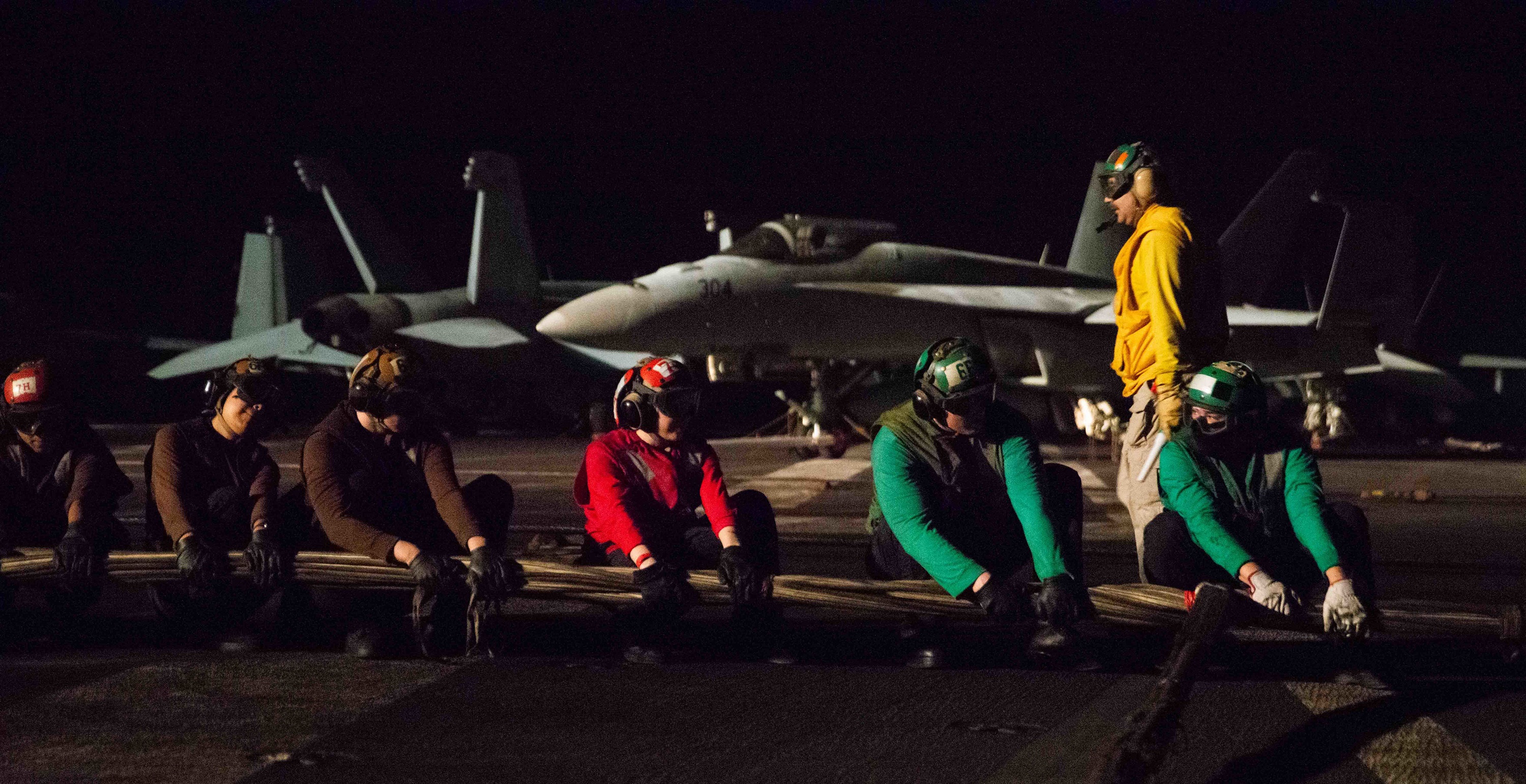 Sailors set up a barricade on the flight deck of the aircraft carrier Ronald Reagan during a damage control drill in the Gulf of Aden July 13. The Reagan is deployed to U.S. 5th Fleet to ensure maritime stability and security in the Central Command region. (MCSN Gray Gibson/Navy)