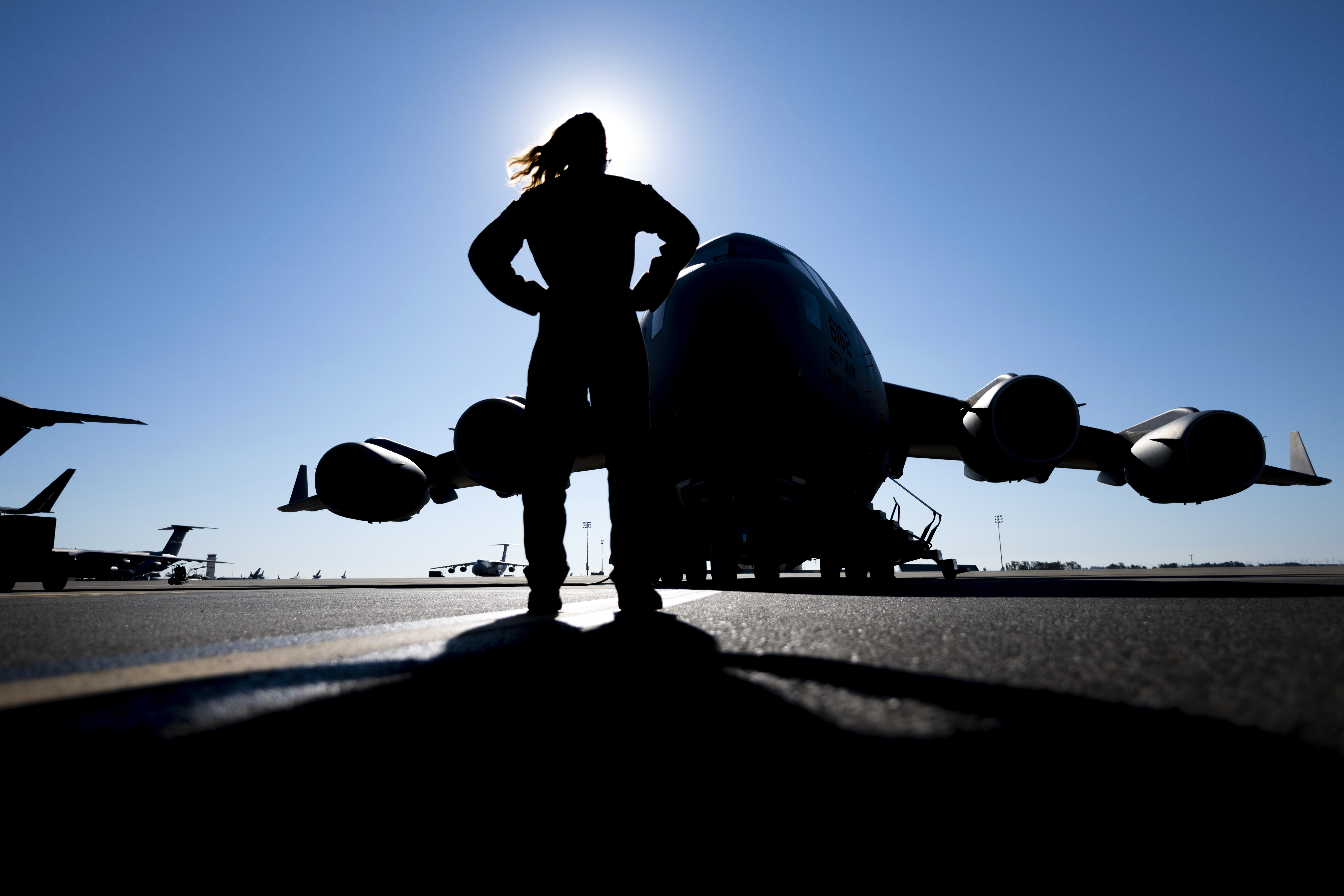 Senior Airman Sara Marinelli, a loadmaster with the 21st Airlift Squadron, stands in front of a C-17 Globemaster III July 6 at Travis Air Force Base, California. The 21st AS conducted a training mission that enabled qualification currency for seven crew members. (Senior Airman Jonathon Carnell/Air Force)