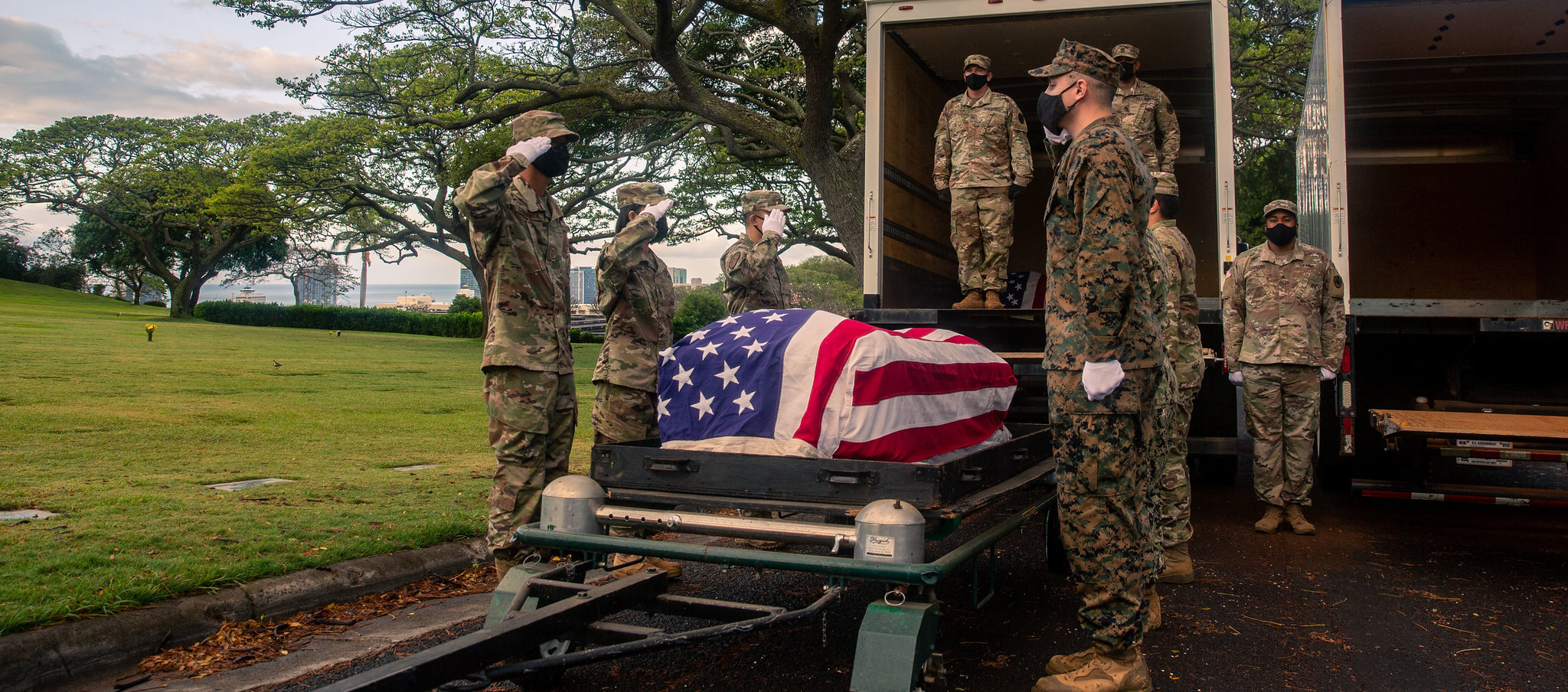 Members of the Defense POW/MIA Accounting Agency (DPAA) salute a casket while participating in a disinterment ceremony at the National Memorial Cemetery of the Pacific, Honolulu, Hawaii, April 19, 2021. The ceremony was part of DPAA’s efforts to disinter the remains of unknown service members lost during the Korean War. (Sgt. Jacqueline A. Clifford/Marine Corps)