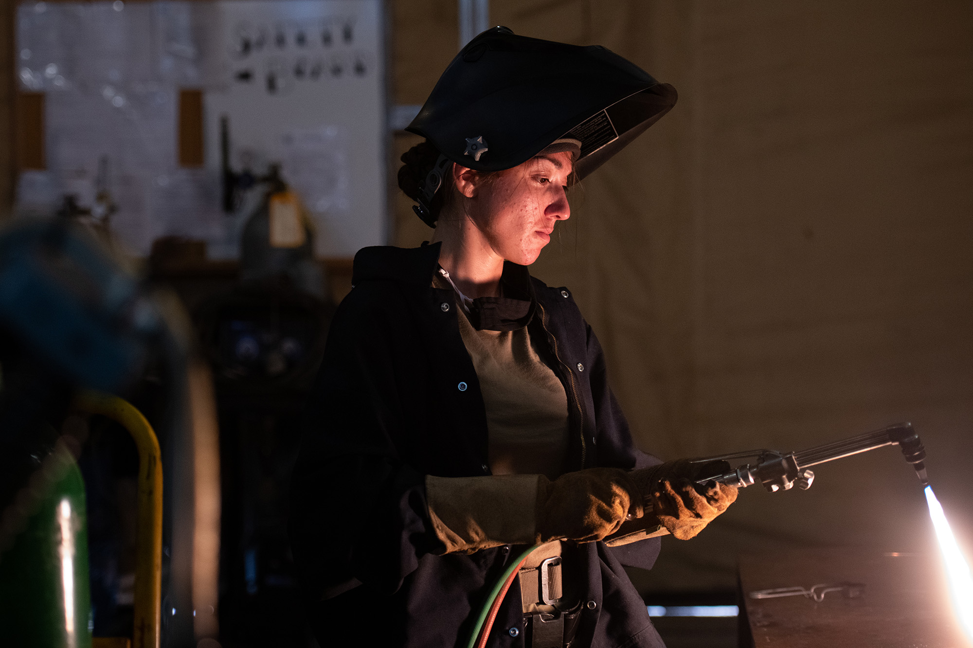 Staff Sgt. Natalie Delgado, an aircraft metals technician deployed to the 332d Air Expeditionary Wing, lights a torch preparing to cut metal on Sept. 24, 2020, in an undisclosed location. (Master Sgt. Jonathan Young/Air National Guard)