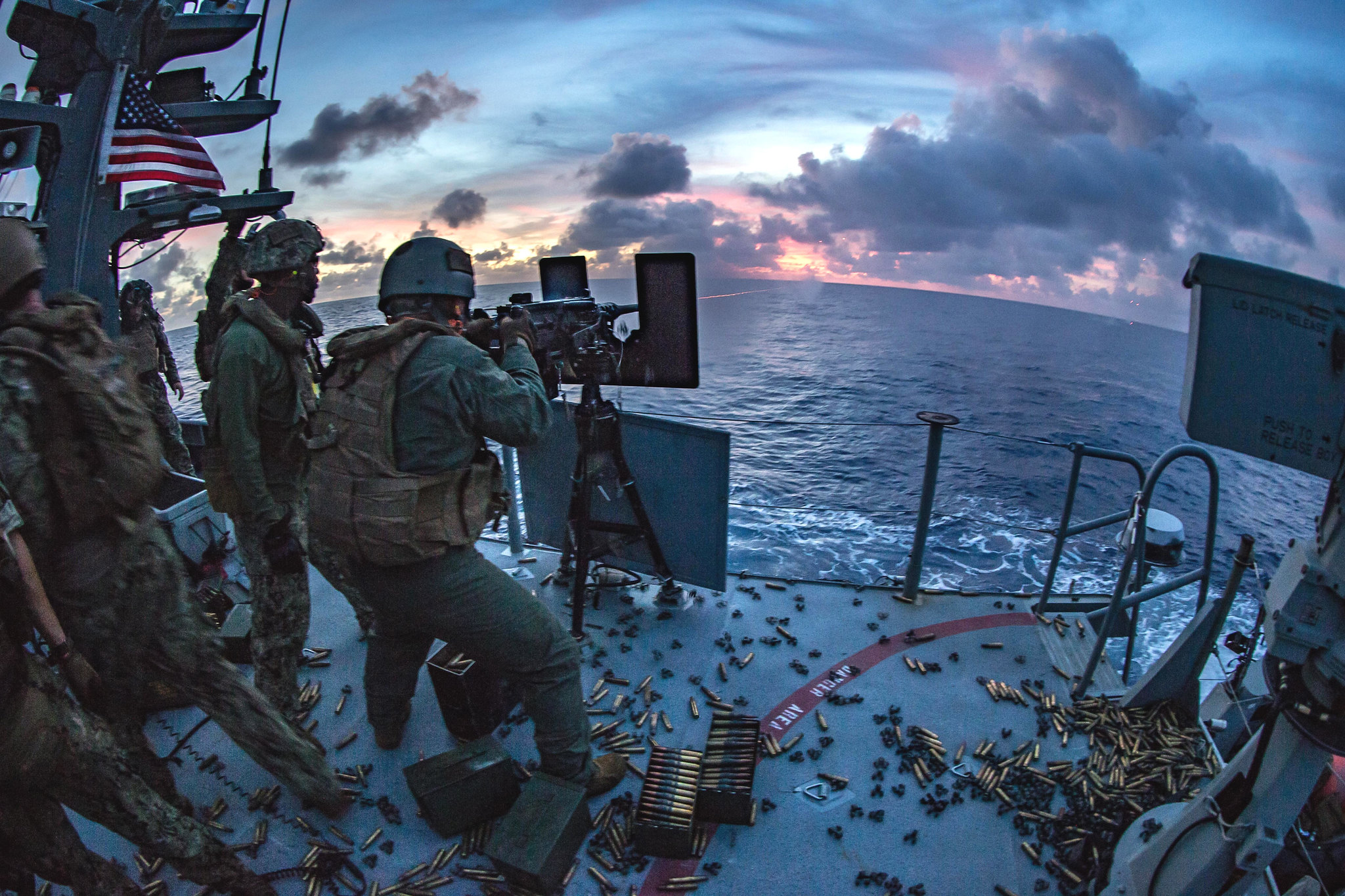 A sailor fires an M2 .50-caliber machine gun on a Mark VI patrol boat during a live-fire exercise in the Philippine Sea, Feb. 27, 2021. (Lance Cpl. Brienna Tuck/Marine Corps)