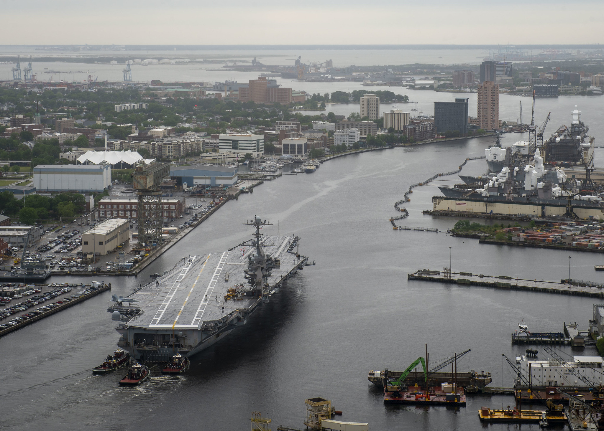 The aircraft carrier USS Harry S. Truman (CVN 75) transits the Elizabeth River on May 12, 2021, as it departs Norfolk Naval Shipyard in Portsmouth, Va., after completing a 10-month scheduled extended carrier incremental availability. (MC2 Class Steven Edgar/Navy)