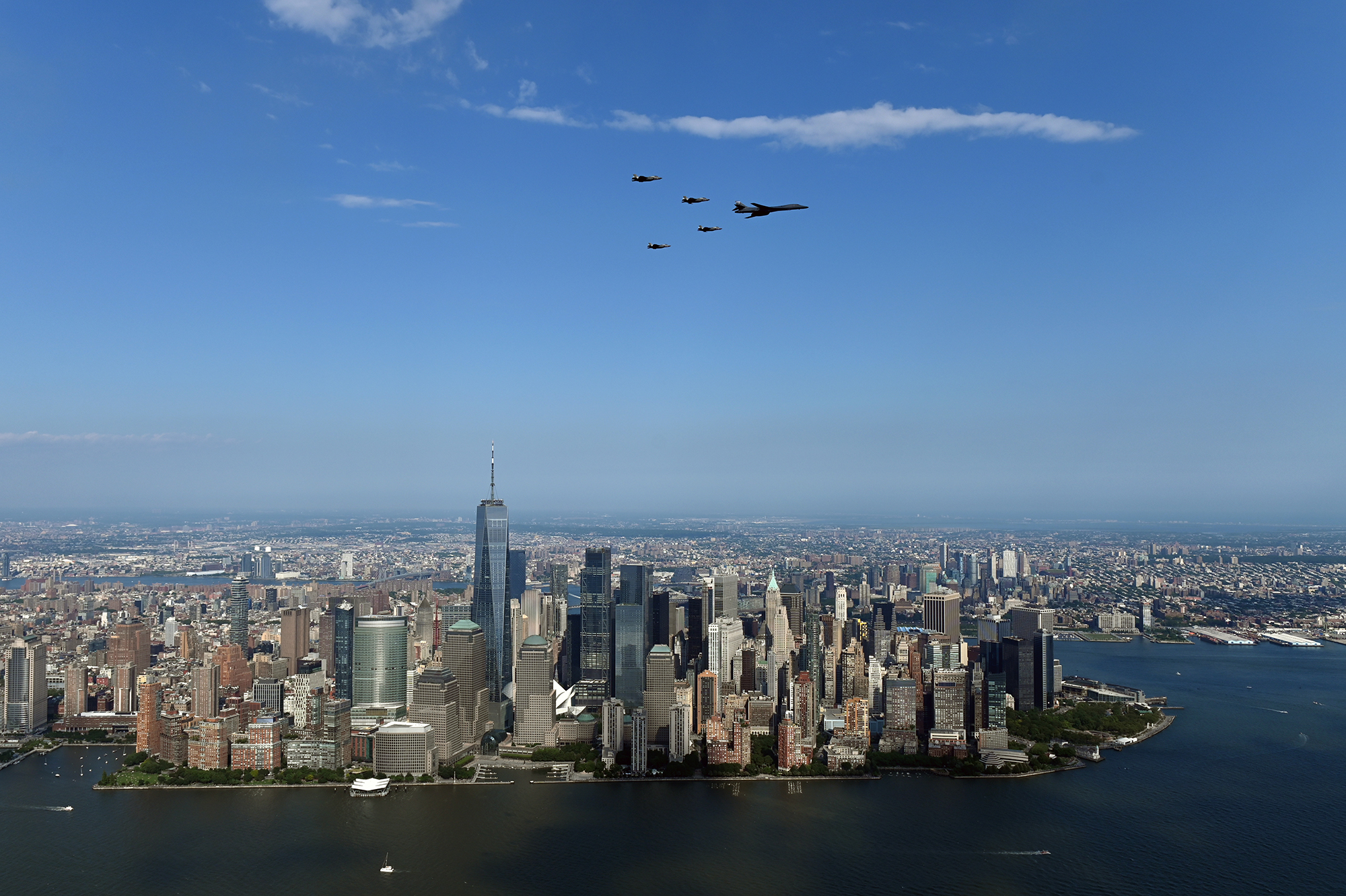 A B-1Lancer flies in formation with four F-35 Lightning II fighters over Manhattan as part of the