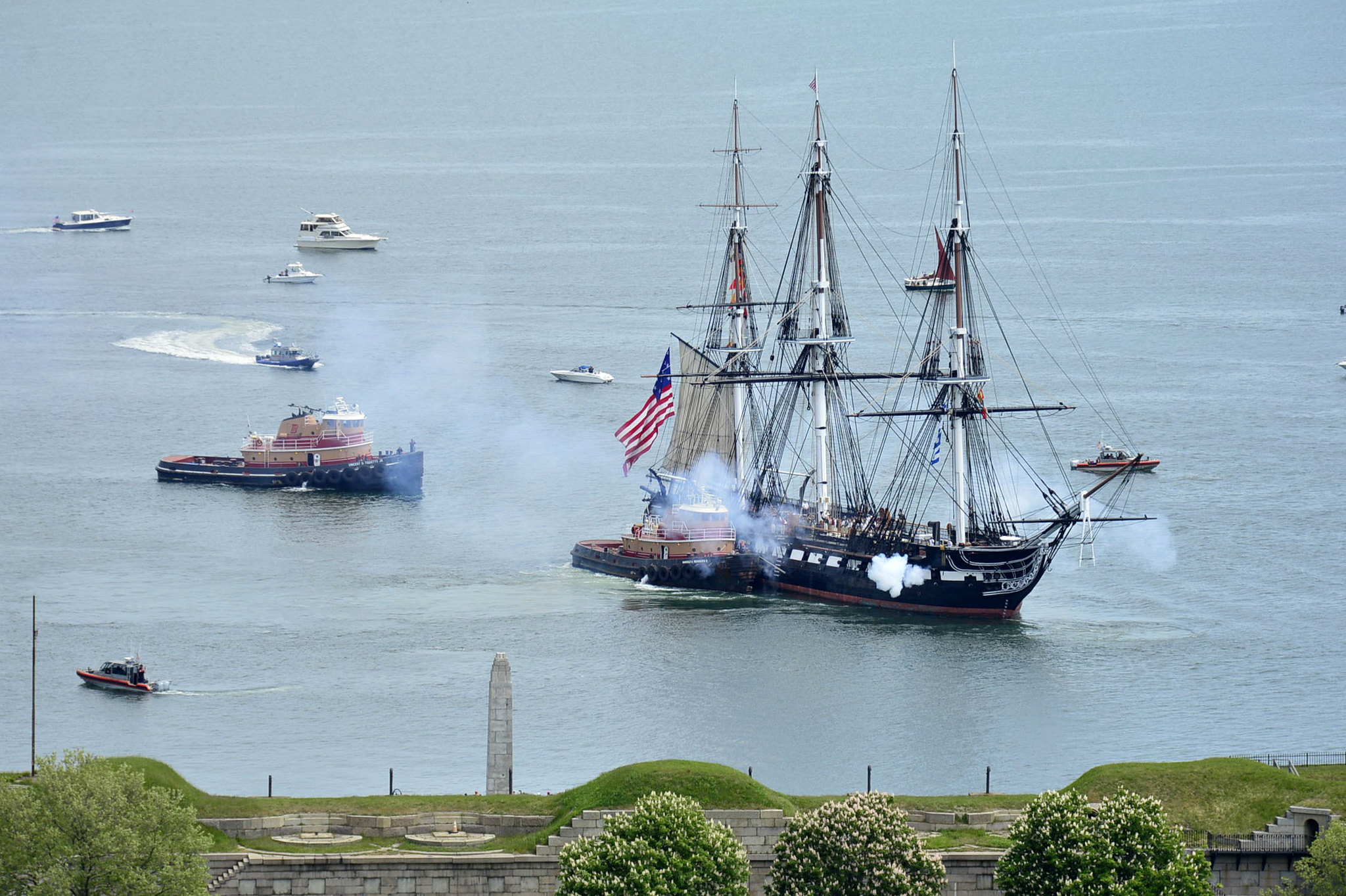 USS Constitution fires its cannons on May 22, 2021, as it is tugged through Boston Harbor. (MC3 Alec Kramer/Navy)