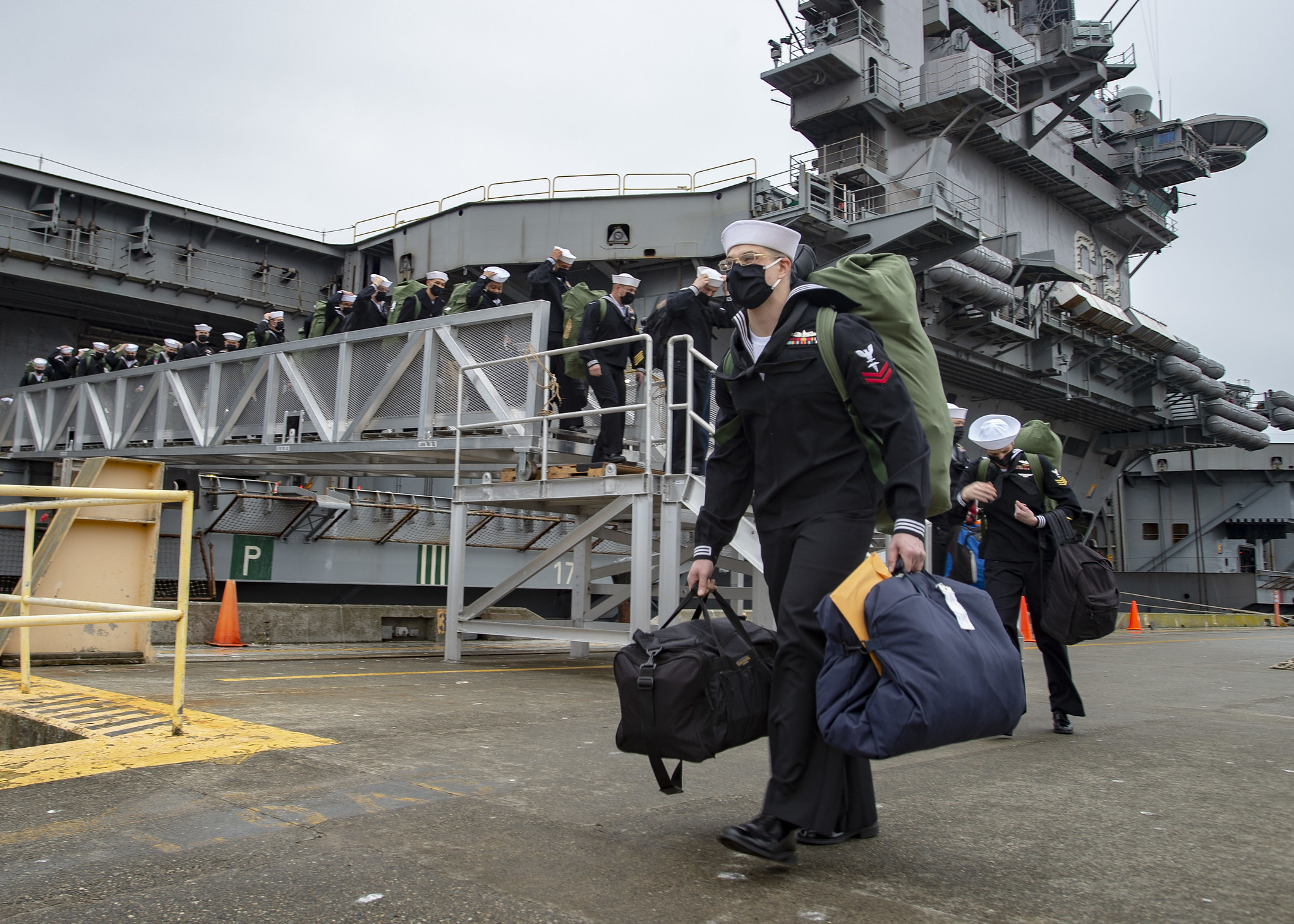 Sailors disembark the aircraft carrier USS Nimitz (CVN 68) at Naval Magazine Indian Island, Wash., on March 4, 2021. Nimitz, part of Nimitz Carrier Strike Group, returned to the Pacific Northwest after more than 11 months following a deployment to U.S. 5th and U.S. 7th Fleets. (MC2 Eleanor Vara/Navy)
