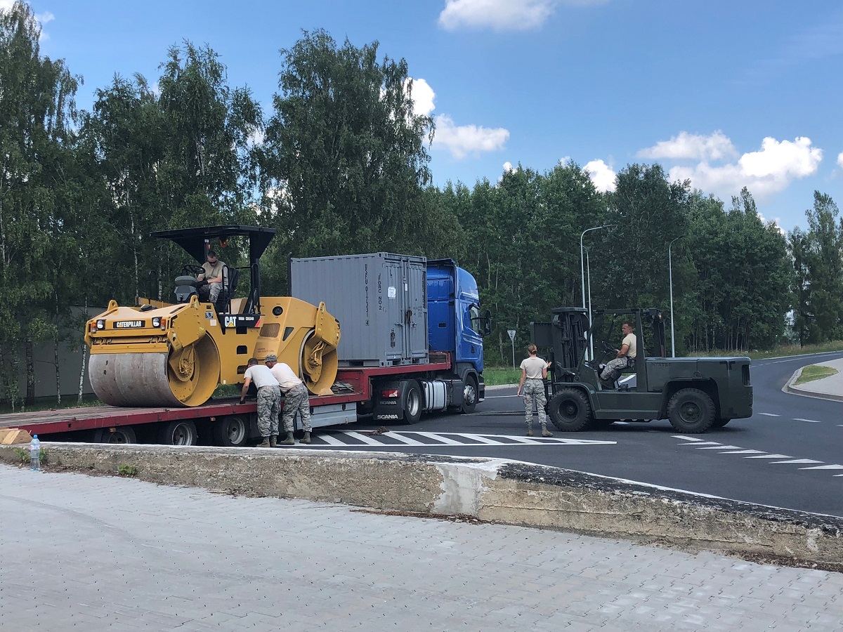 U.S. Air Force personnel, temporarily deployed to the 31st Air Base in Krzesiny, Poland, unload vehicles and shipping containers full of equipment on July 31. The DABS exercise held in July and August will help the service evaluate how quickly it can move materiel onto a partner nation's base. (Valerie Insinna/Staff)