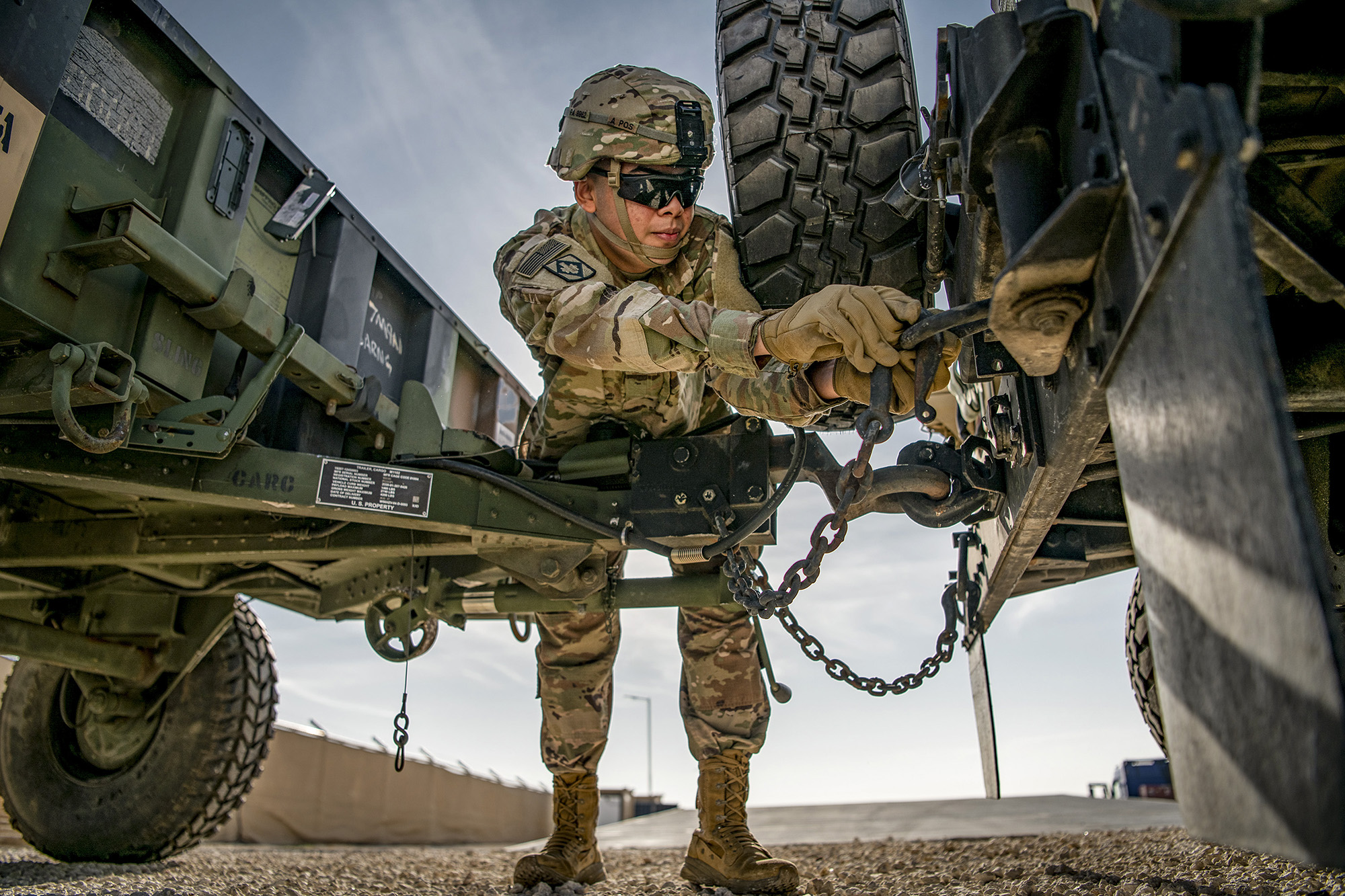 Pvt. 1st Class Pablo Aguirre secures an M1101 trailer to the back of a high mobility multipurpose wheeled vehicle on Dec. 22, 2020, in support of Operation Spartan Shield and Operation Inherent Resolve. (Sgt. Dustin D. Biven/Army)
