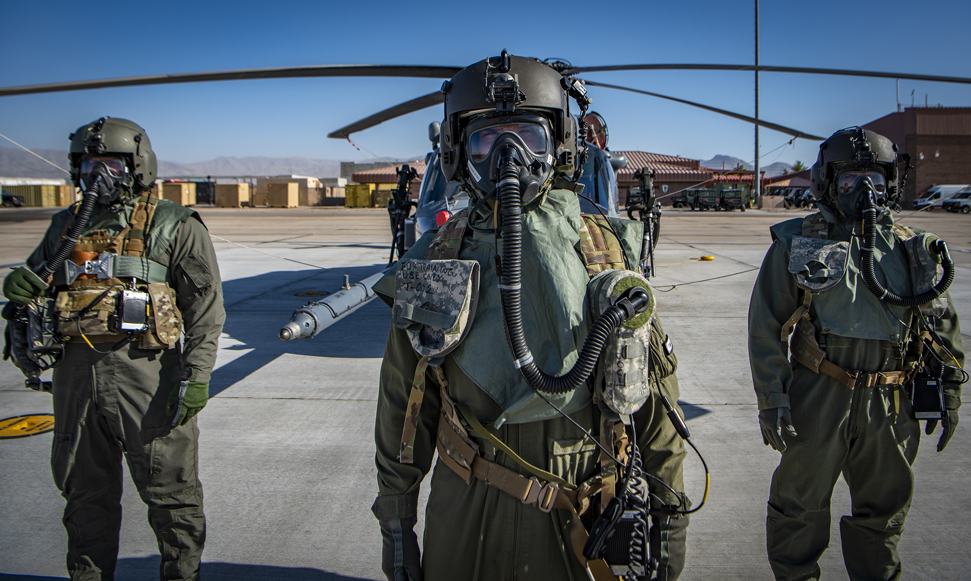 Airmen assigned to the 88th Test and Evaluation Squadron pose for a photo in full Chemical, Biological, Radiological, and Nuclear flight gear during a developmental test at Nellis Air Force Base, Nev., April 21, 2021. The airmen participated in on-going testing of the new Uniform Integrated Protective Ensemble Air two-piece system. (Senior Airman Dwane R. Young/Air Force)