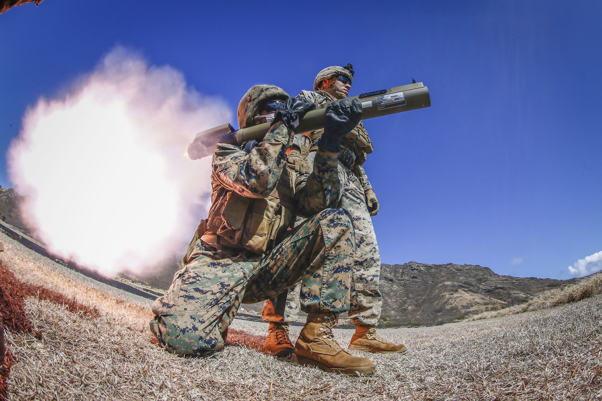 Sgt. Isaac Zimmerman observes as a Marine fire an M72 LAW weapon system at Marine Corps Base Hawaii, Aug. 13, 2020. (Sgt. Luke Kuennen/Marine Corps)