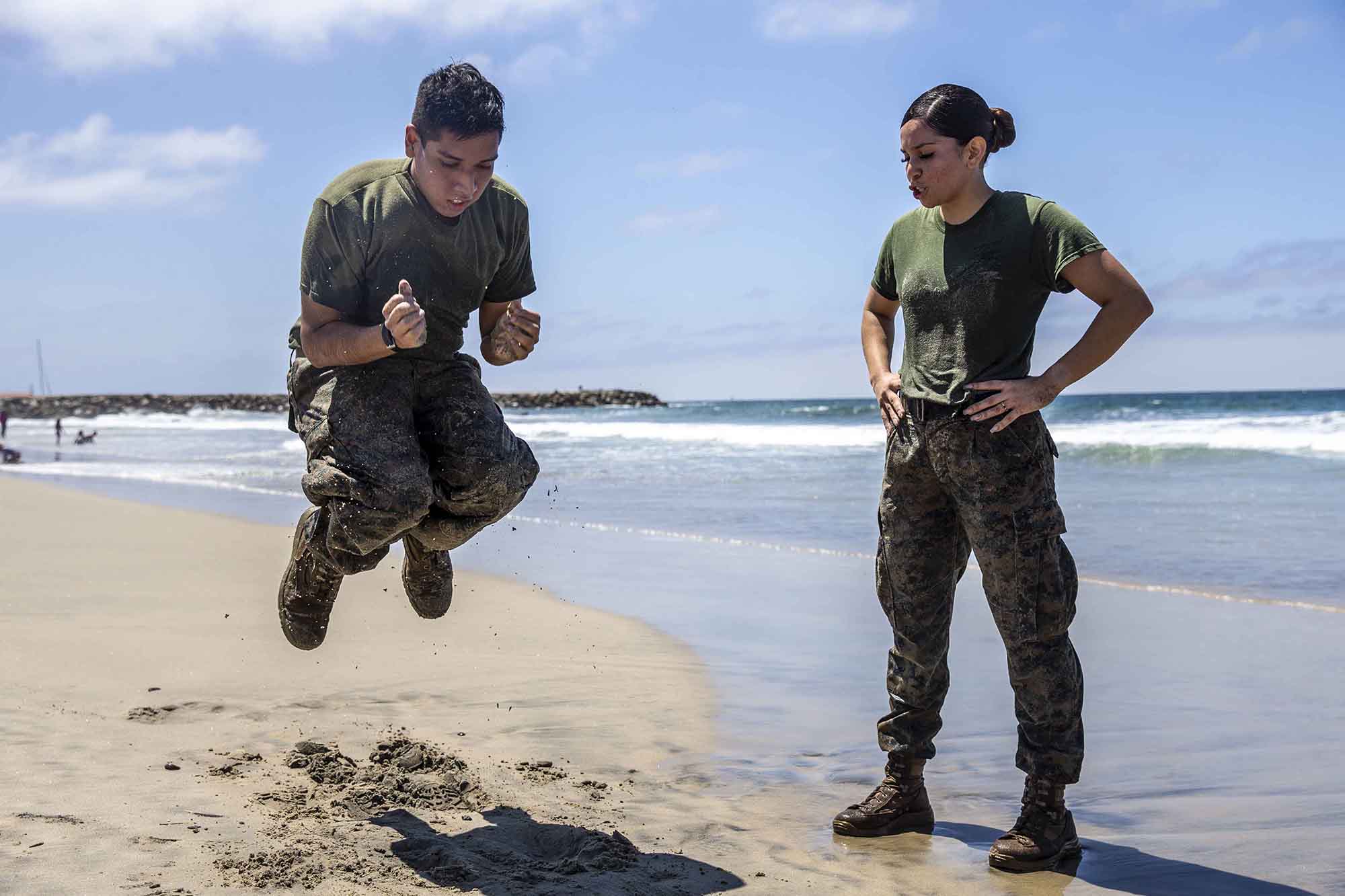U.S. Marine Sgt. Roxanne Gorostieta motivates a fellow Marine during a physical training session at Del Mar Beach on Marine Corps Base Camp Pendleton, Calif., Aug. 5, 2020. (Lance Cpl. Alison Dostie/Marine Corps)