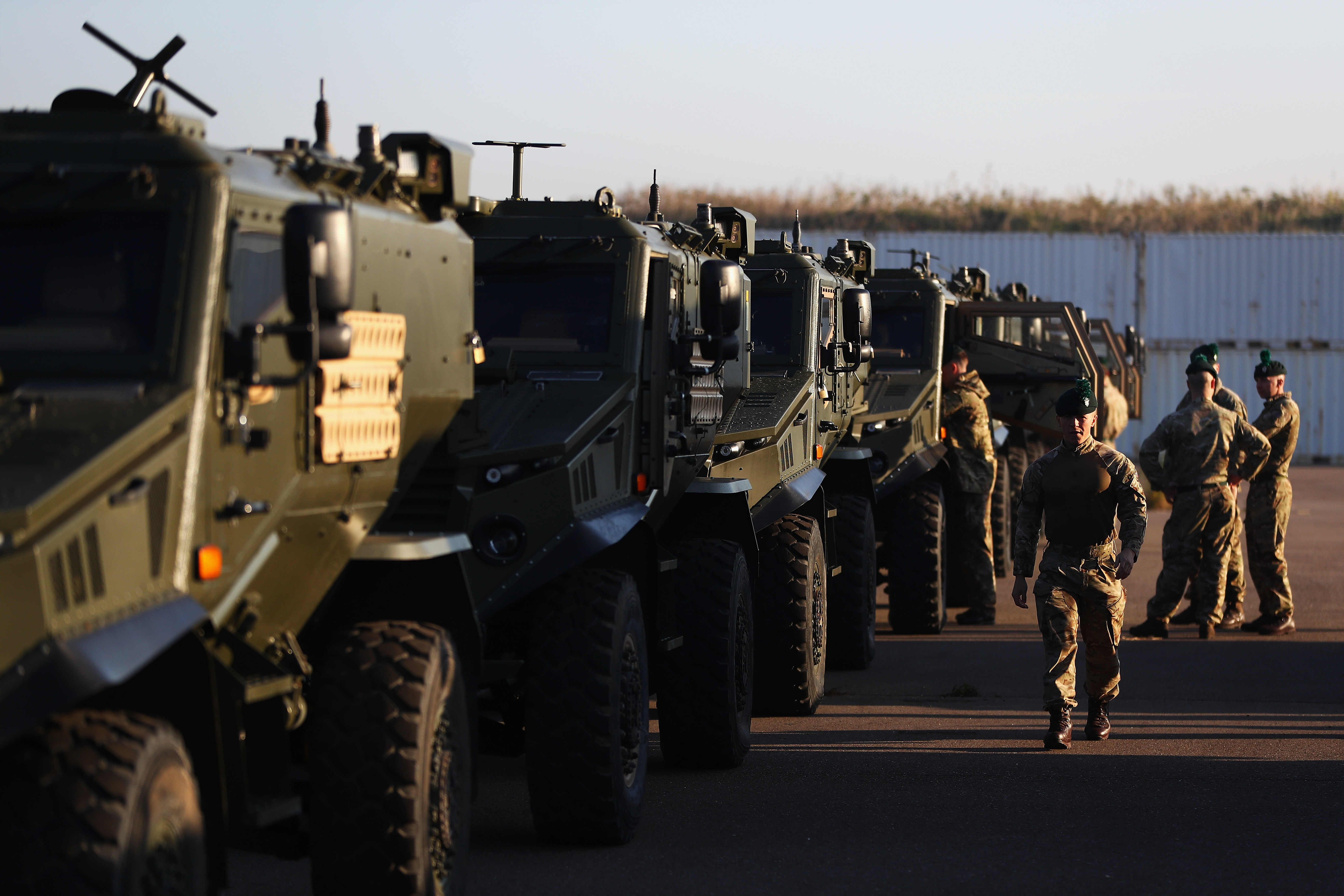 British and Irish soldiers with their military vehicles pause to check equipment and rest on Oct. 10, 2018, in Rotterdam, Netherlands. They were on their way to join other NATO forces for Operation Trident Juncture. Norway has long lobbied NATO partners to increase troop numbers as Russia has built up its military capacity in the region, especially the Kola Peninsula inside the Arctic Circle. (Dean Mouhtaropoulos/Getty Images)