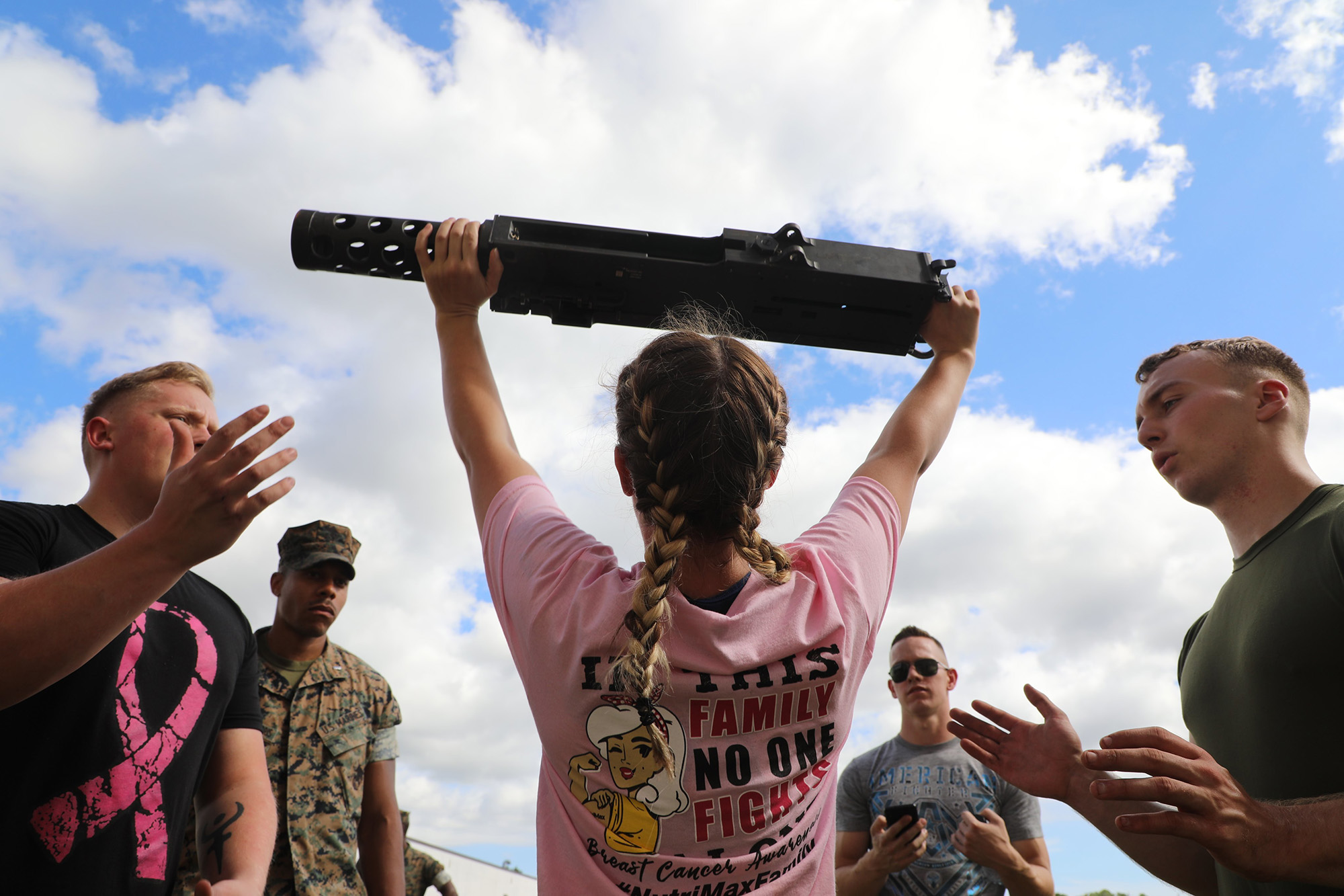 Cpl. Alexandra Veal executes an overhead press with an M2 .50 caliber machine gun during the unit’s Warrior Week competition at Camp Lejeune, N.C., Oct. 15, 2020. (Lance Cpl. David I. Romero/Marine Corps)