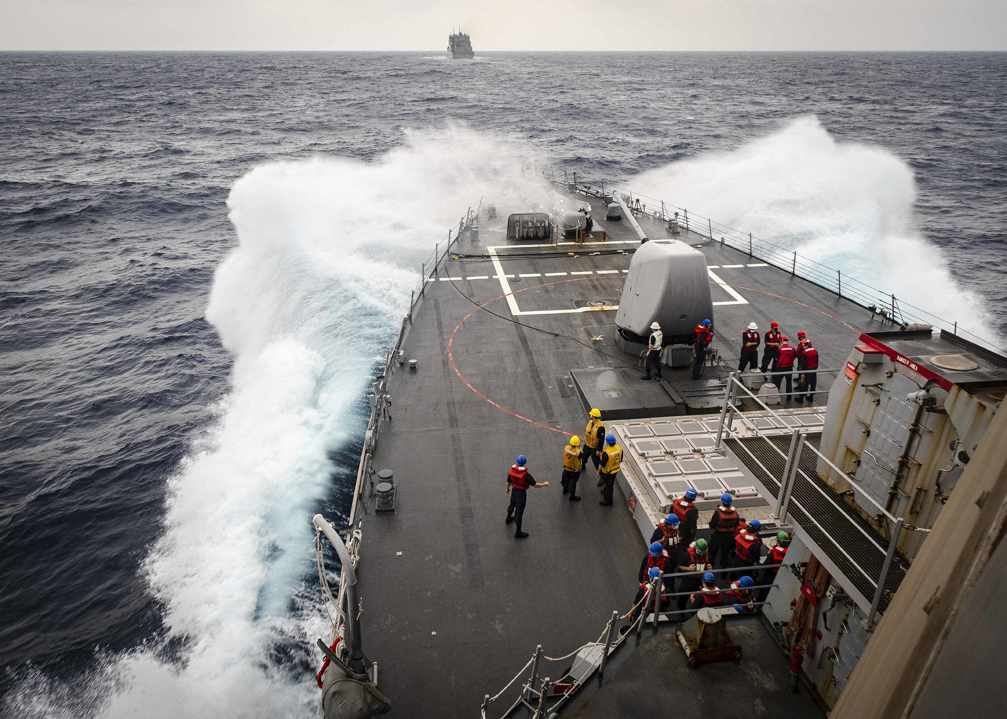 Sailors observe from the foc’s’le as the Arleigh Burke-class guided-missile destroyer USS John S. McCain (DDG 56) makes its approach towards the dry cargo and ammunition ship USNS Alan Shepard (T-AKE 3) prior to a replenishment-at-sea on Oct. 22, 2020, in the South China Sea. (MC2 Markus Castaneda/Navy)