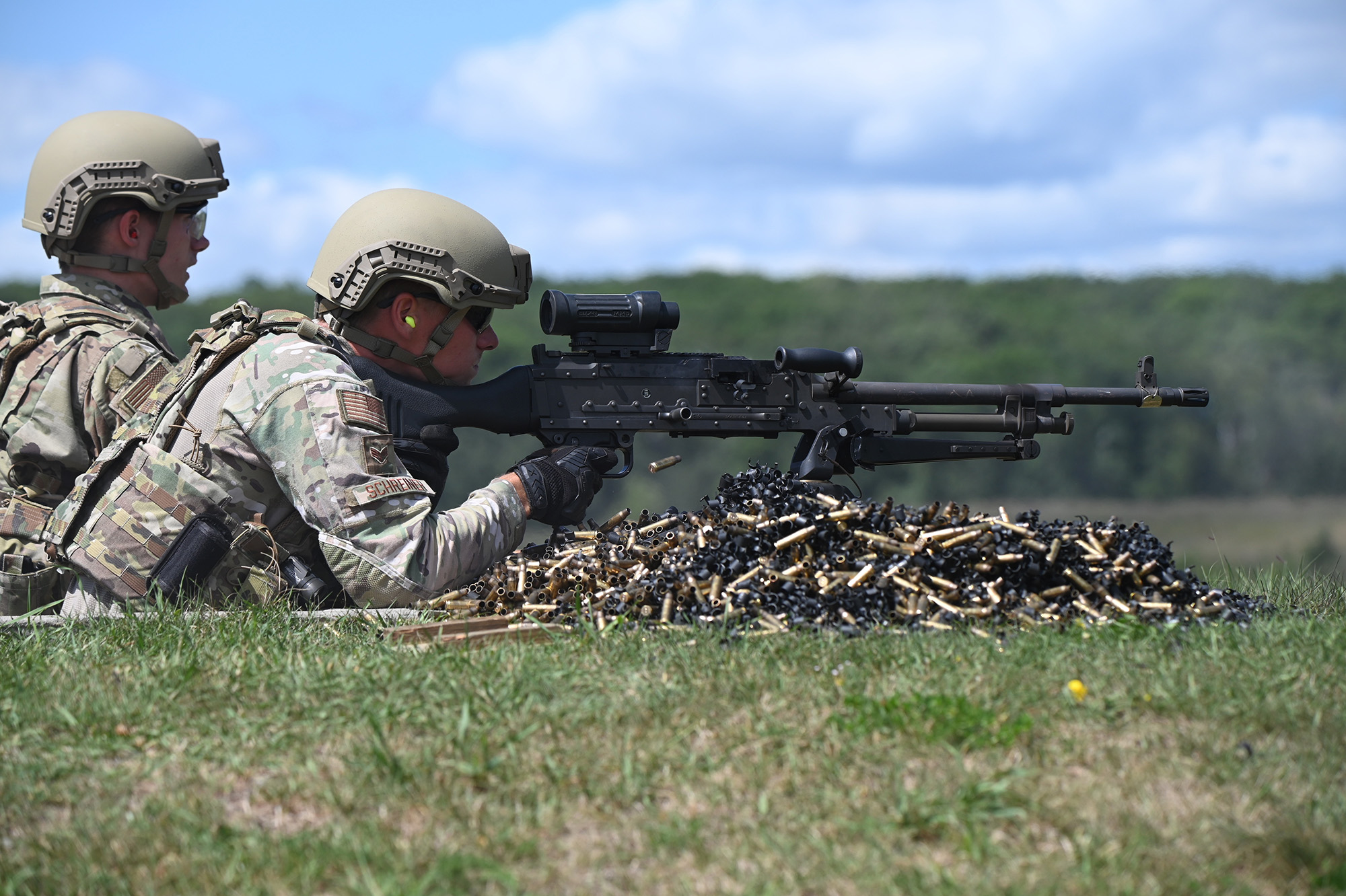 Senior Airman Brian Schreiner, 119th Security Forces Squadron, fires an M240 machine gun at firing-range targets at Camp Ripley Training Center, Minn., Aug. 3, 2020. (Chief Master Sgt. David H. Lipp/Air National Guard)