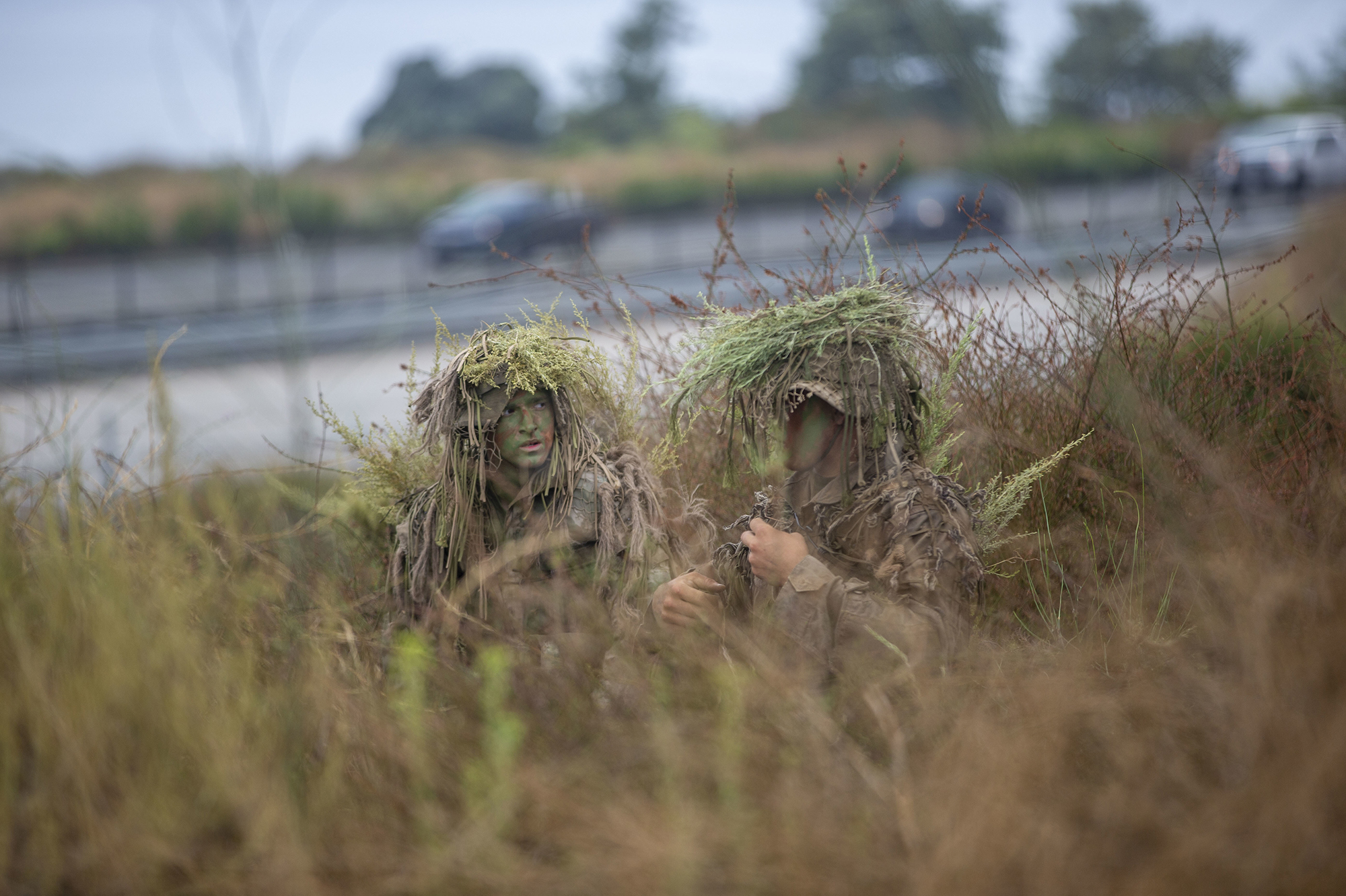 Marines with the Scout Sniper Course, Reconnaissance Training Company, Advanced Infantry Training Battalion, School of Infantry - West, work to conceal themselves during an exercise in the Romeo Training Area on Marine Corps Base Camp Pendleton, Calif., July 27, 2020. (Lance Cpl. Drake Nickels/Marine Corps)