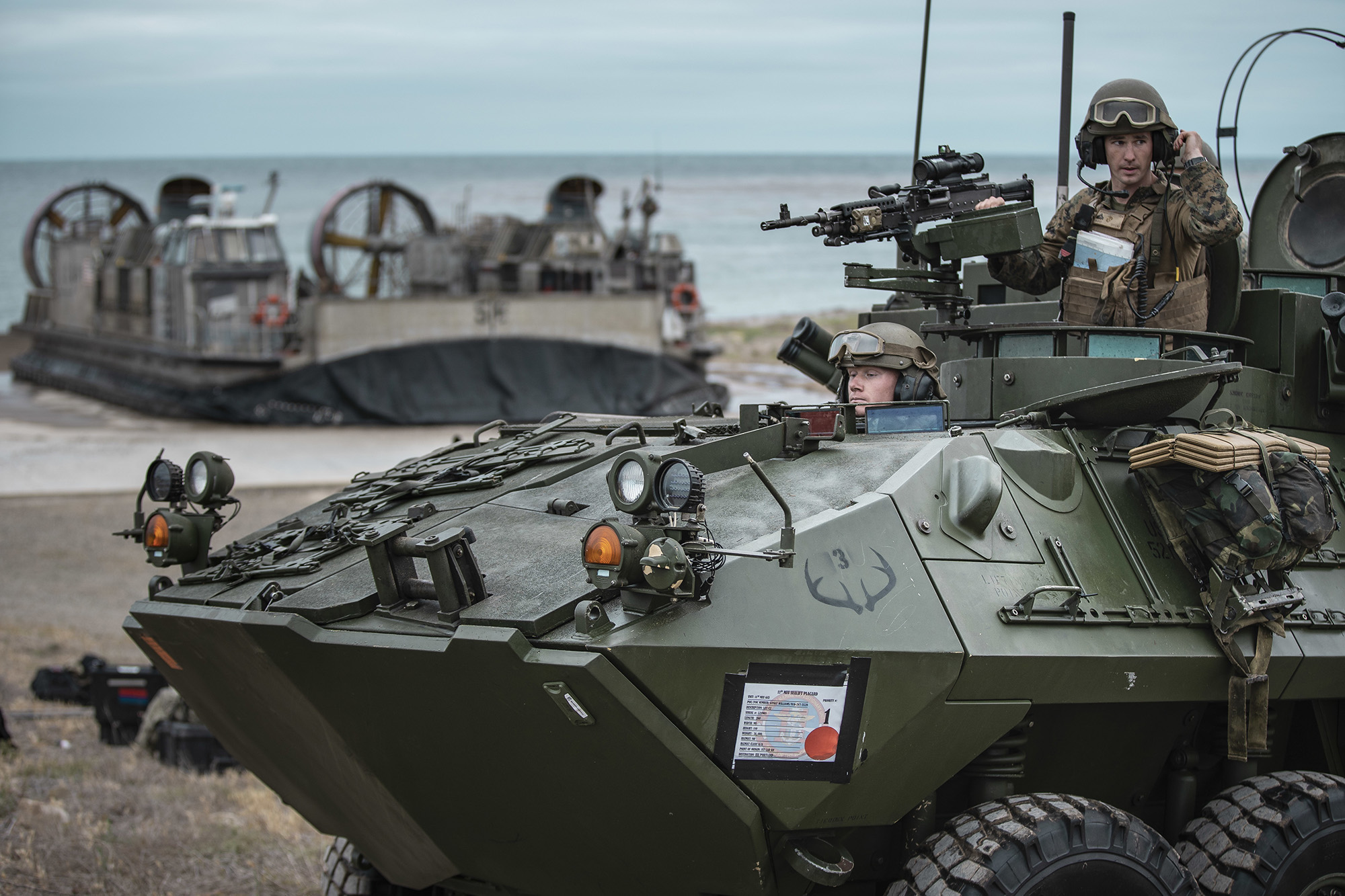 Marines offload a light armored vehicle during an expeditionary advance base exercise at San Clemente Island, Calif., May 15, 2021. (Sgt. Alexis Flores/Marine Corps)