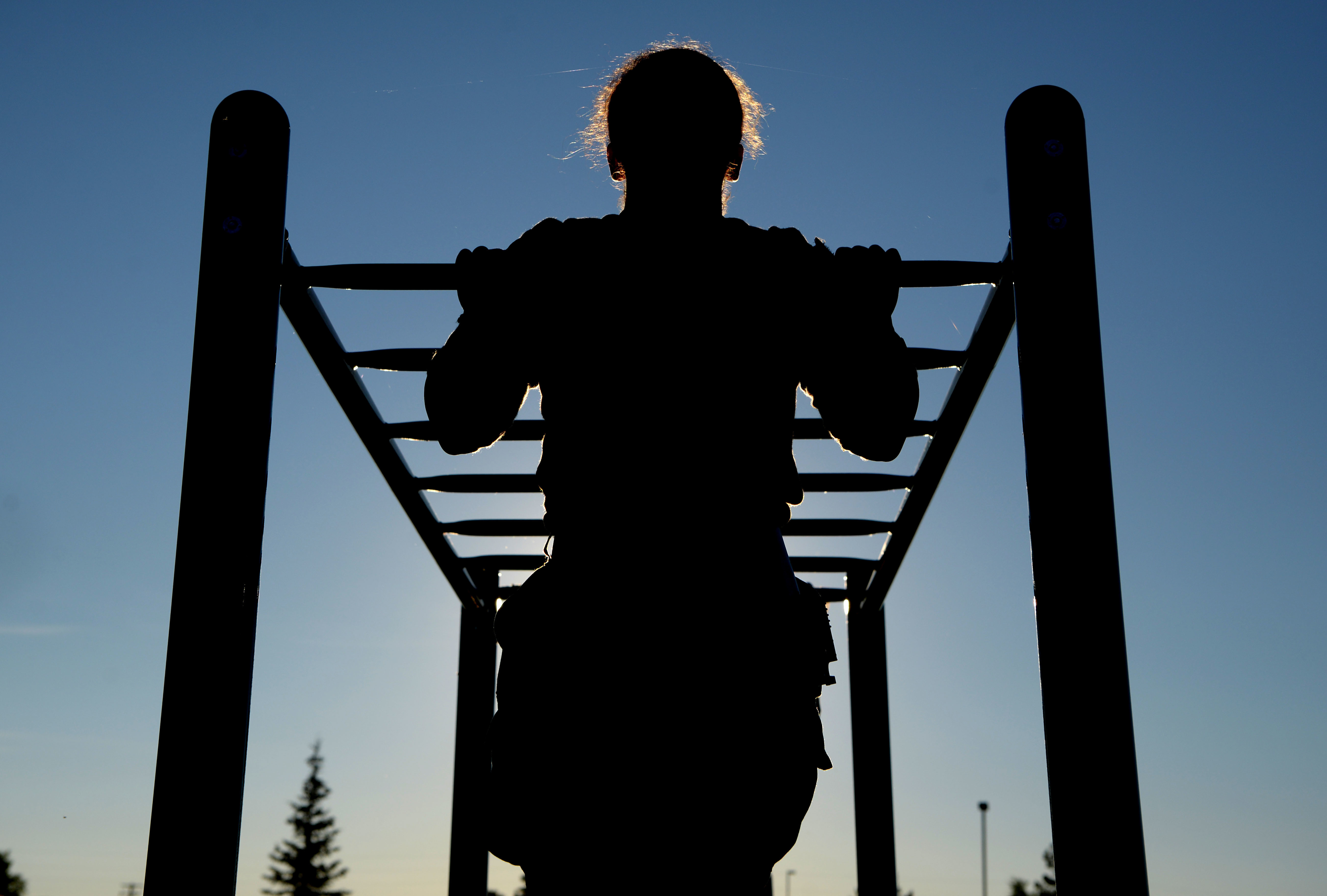 Airman 1st Class Alexandranell Soto, 354th Security Forces Squadron response force leader, completes a pullup during a special weapons and tactics physical training test at Eielson Air Force Base, Alaska, June 23. (Senior Airman Beaux Hebert/Air Fprce)