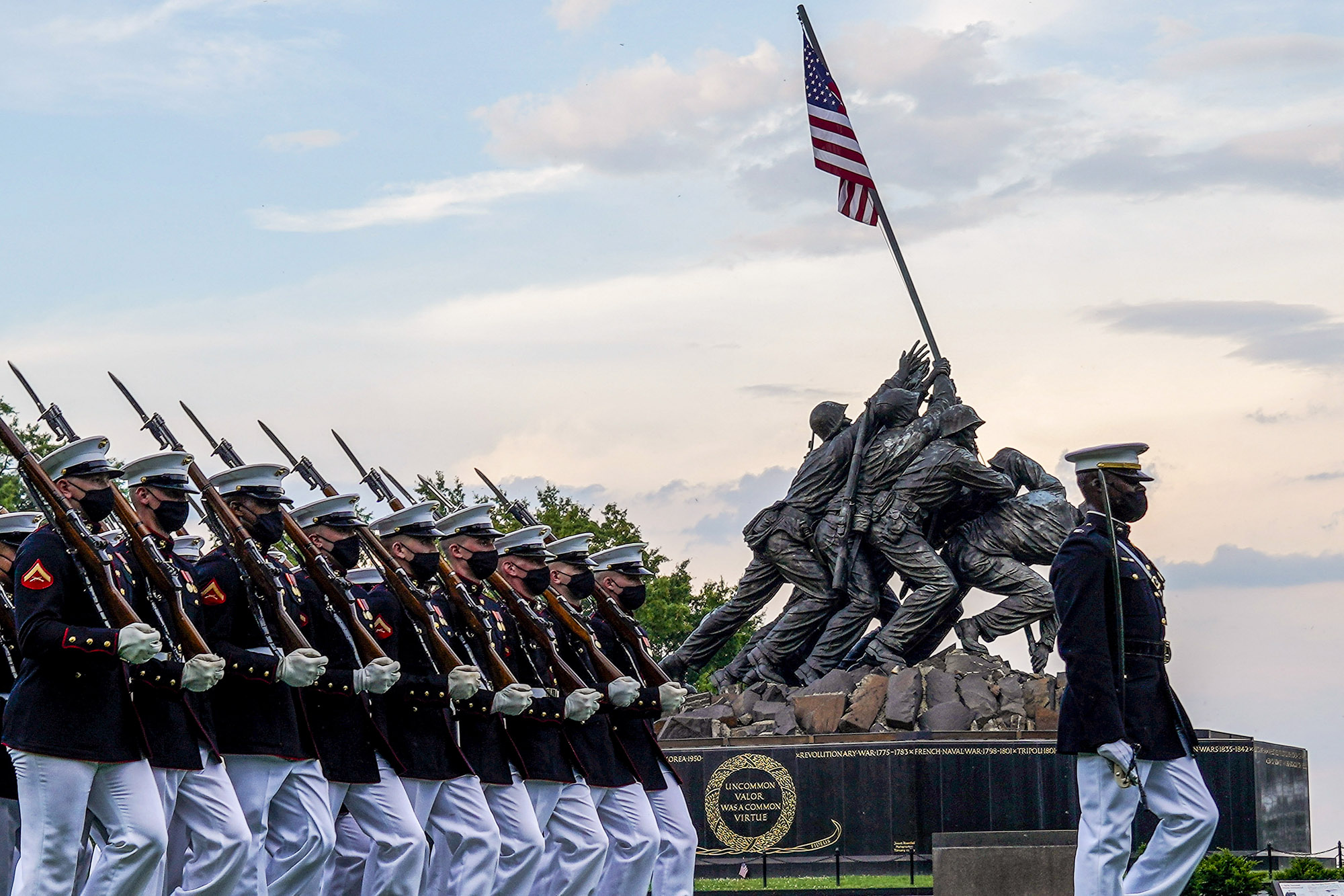 Marines with the Silent Drill Platoon march for “Pass in Review” during a Tuesday Sunset Parade at the Marine Corps War Memorial, Arlington, Va., June 8, 2021. (Sgt. Jason Kolela/Marine Corps)
