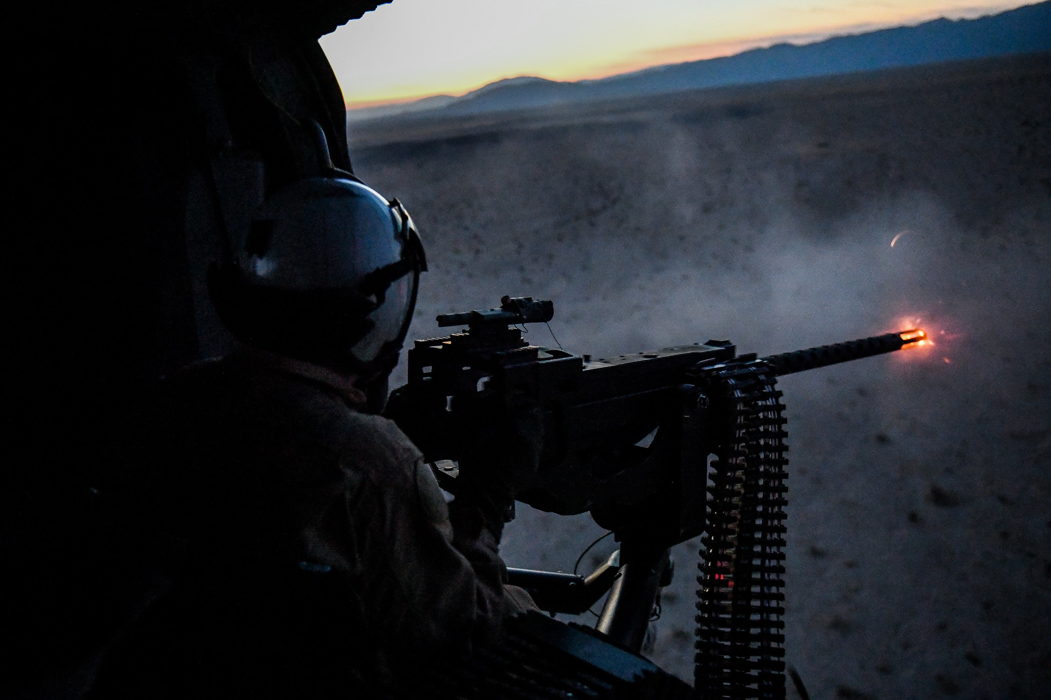Naval Aircrewman (Helicopter) 3rd Class Copper McCambridge fires a .50-caliber machine gun during an initial aerial gunnery training qualification at Naval Air Facility El Centro, Calif, on Oct. 10, 2020. (Chief Mass Communication Specialist Shannon Renfro/Navy)