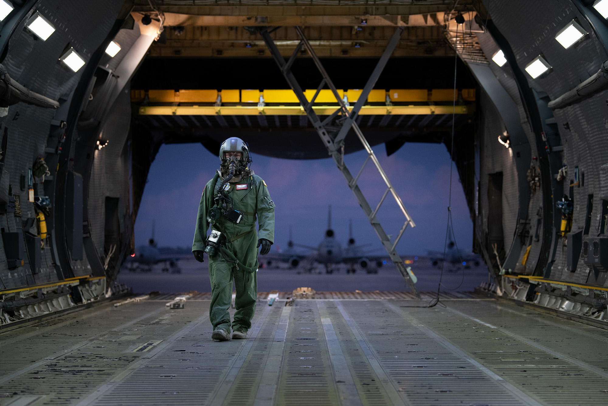 Staff Sgt. Cameron DiMatteo, 22nd Airlift Squadron loadmaster, walks inside a C-5M Super Galaxy during a base exercise Nov. 18, 2020, at Travis Air Force Base, Calif. (Chustine Minoda/Air Force)
