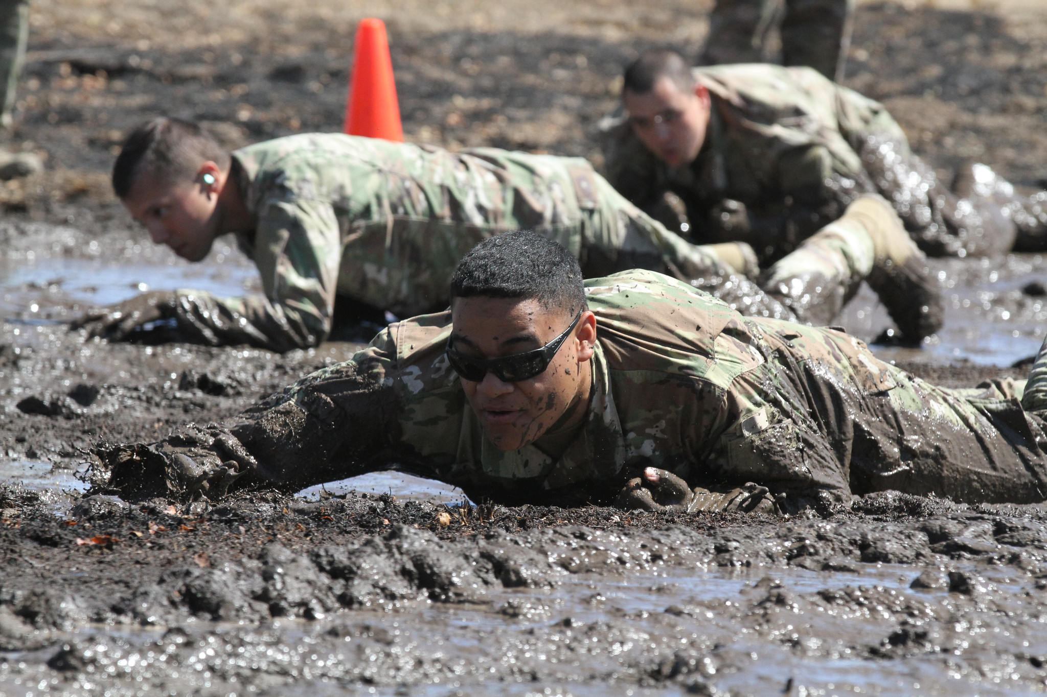 U.S. Army Sgt. Miguel Leyua of the California National Guard’s 330th Military Police Company, 143rd Military Police Battalion, 49th Military Police Brigade, one of the cadres of the 49th’s 2020 Best Warrior Competition, low crawls through a mud pit during the competition, Aug. 8-12, 2020 at Camp Roberts, Calif. (Staff Sgt. Eddie Siguenza/Army National Guard)
