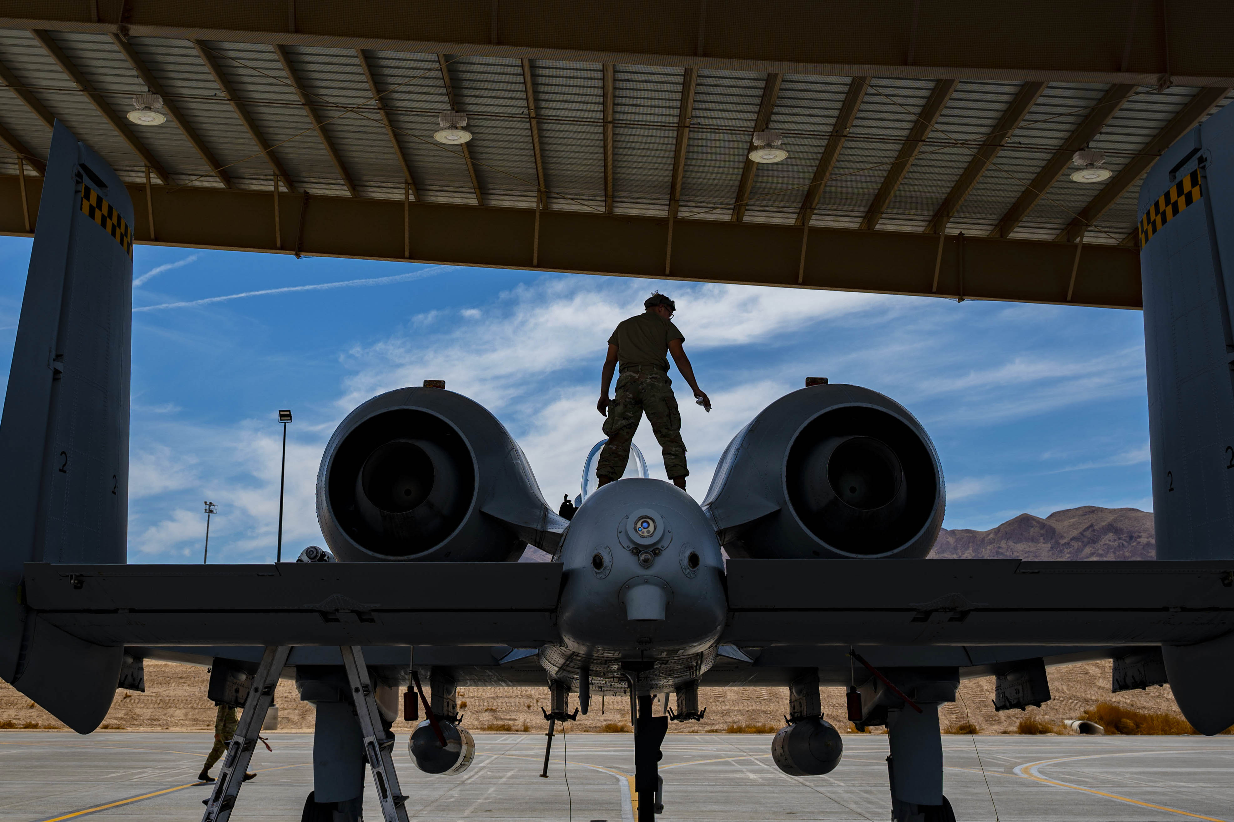 Airman 1st Class Zane Campbell, a tactical aircraft maintainer assigned to the 757th Aircraft Maintenance Squadron, performs maintenance on an A-10 Warthog at Nellis Air Force Base, Nevada, June 26. (Airman 1st Class Zachary Rufus/Air Force)