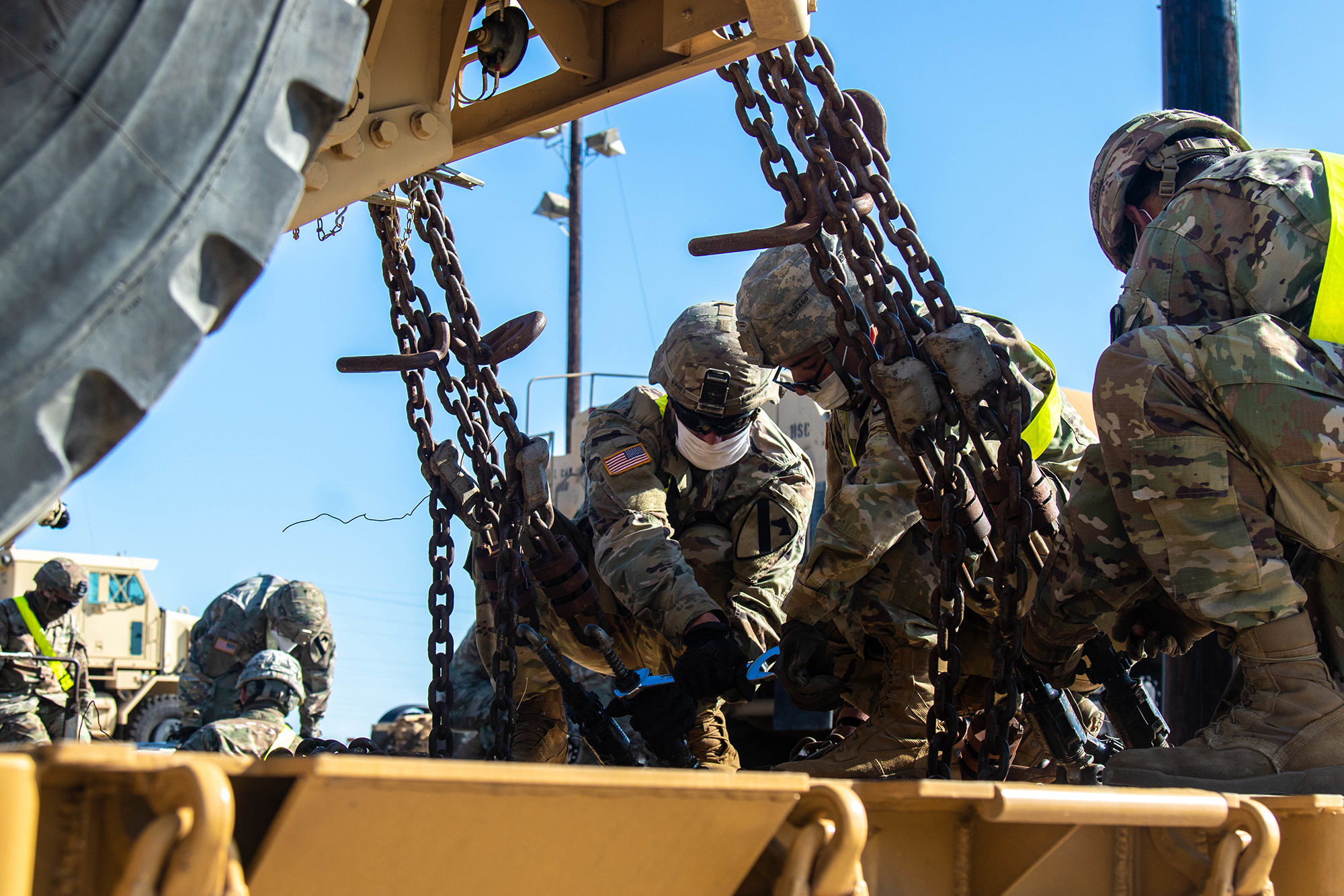 Motor Transport Operators with 1st Cavalry Division Sustainment Brigade unfasten a vehicle from a rail-cart during railhead operations, Fort Hood, Texas, June 8, 2020. (Sgt. Calab Franklin/Army)
