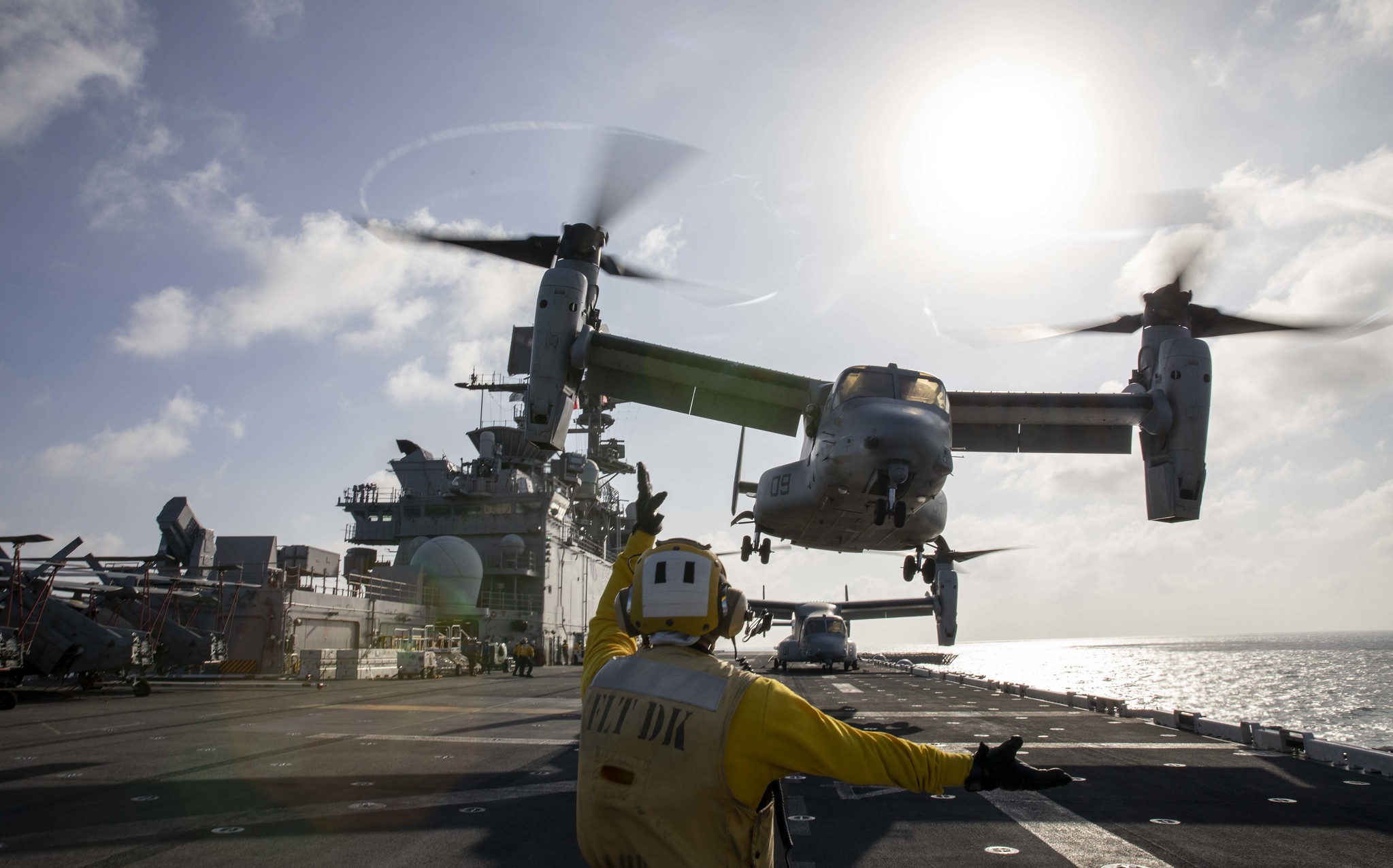 Aviation Boatswain’s Mate (Handling) 2nd Class Skyler Campbell directs a Marine Corps MV-22 Osprey on Jan. 23, 2021, during takeoff from the amphibious assault ship USS Makin Island (LHD 8) in the Indian Ocean. (MC3 Aaron Sperle/Navy)