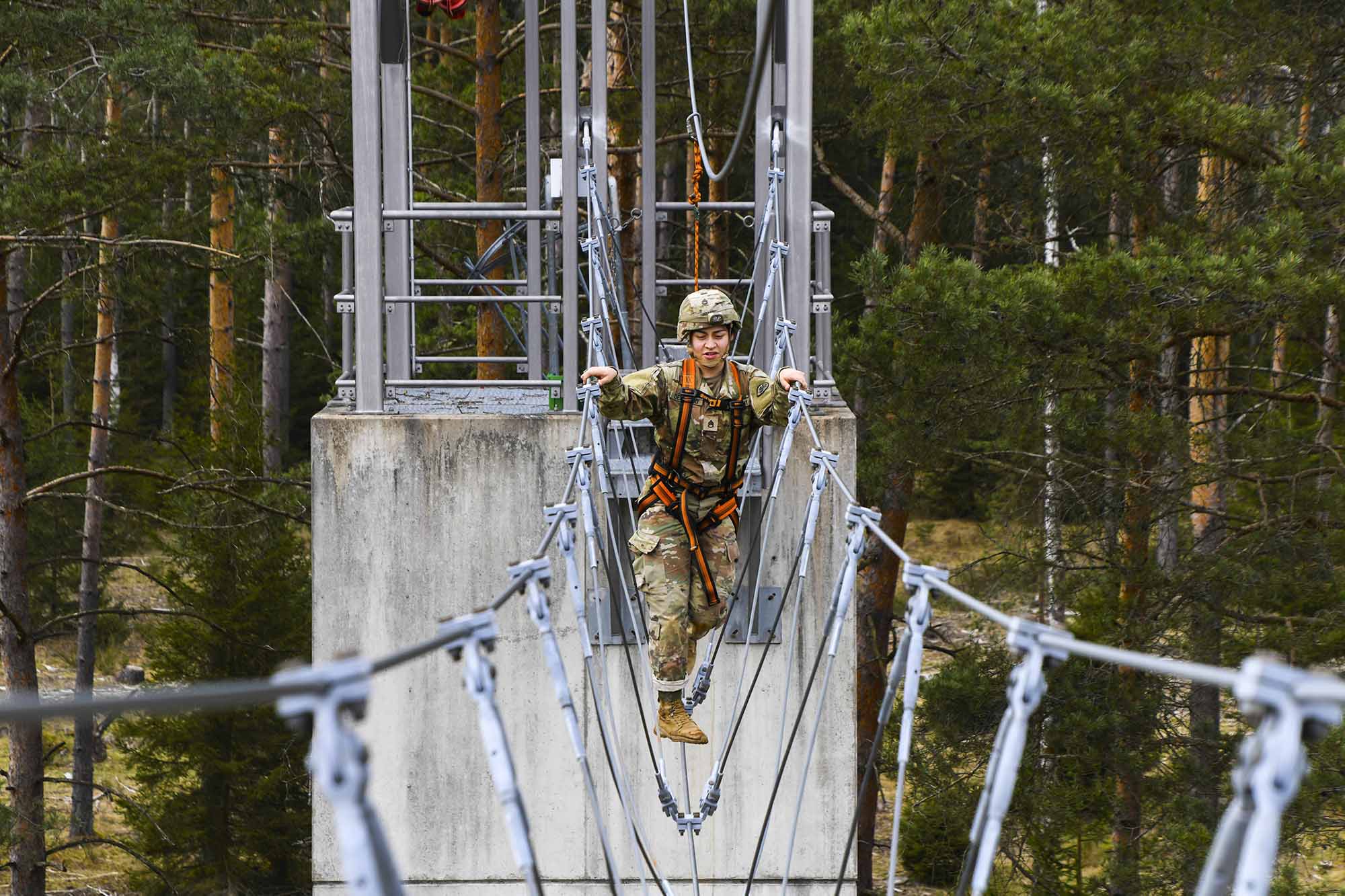 Staff. Sgt. Samantha Delgado crosses a cable bridge during the Army Medical Department Activity Bavaria Best Warrior Competition at the Grafenwoehr Training Area, Germany, April 11, 2021. (Spc. Austin Riel/Army)