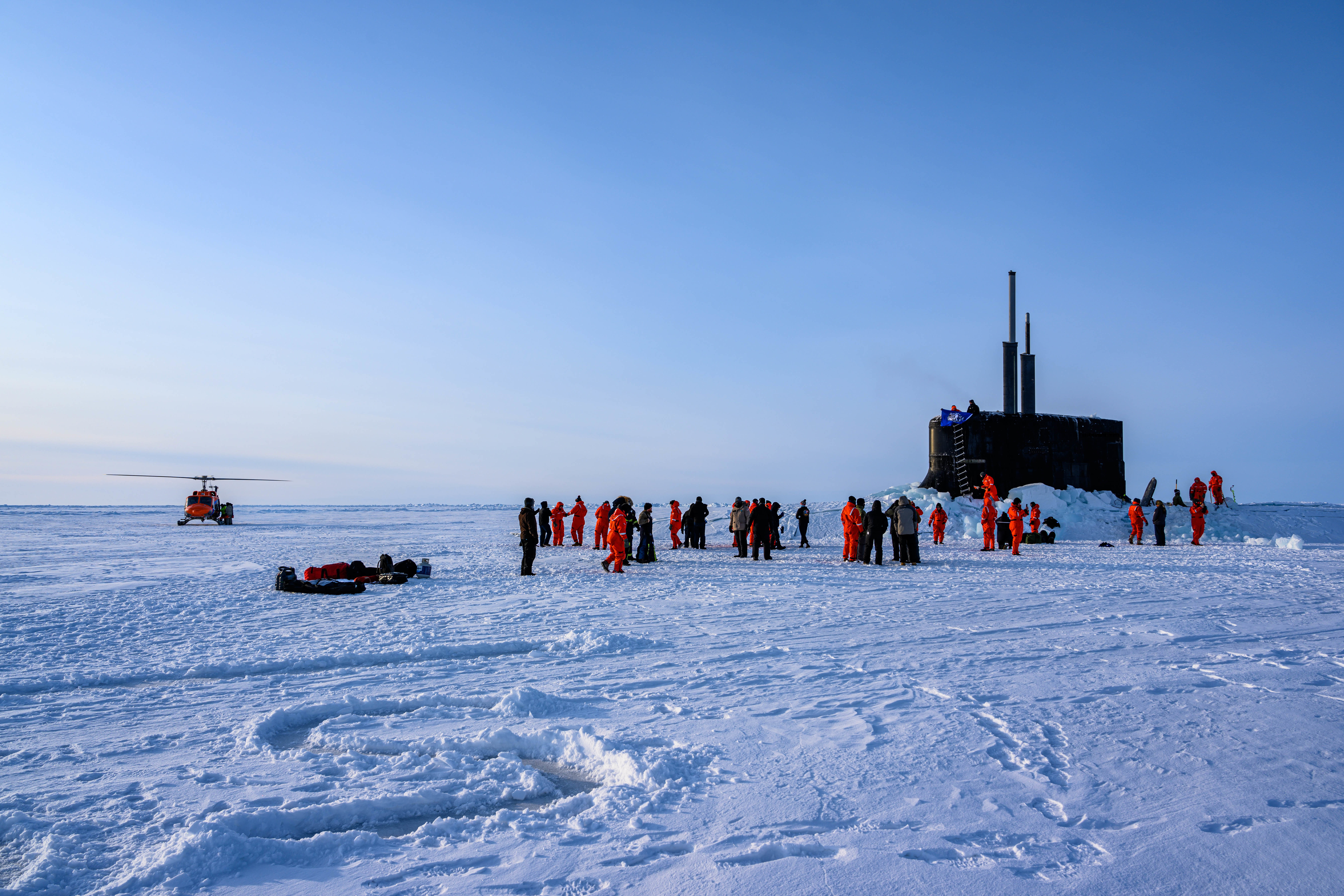 The crew of the U.S. Navy's Seawolf-class submarine Connecticut enjoys ice liberty after surfacing in the Arctic Circle during Ice Exercise 2020 on March 7, 2020. ICEX is a biennial submarine exercise that promotes interoperability between allies and partners to maintain operational readiness and regional stability, while improving capabilities to operate in the Arctic environment. (MC1 Michael B. Zingaro/U.S. Navy)