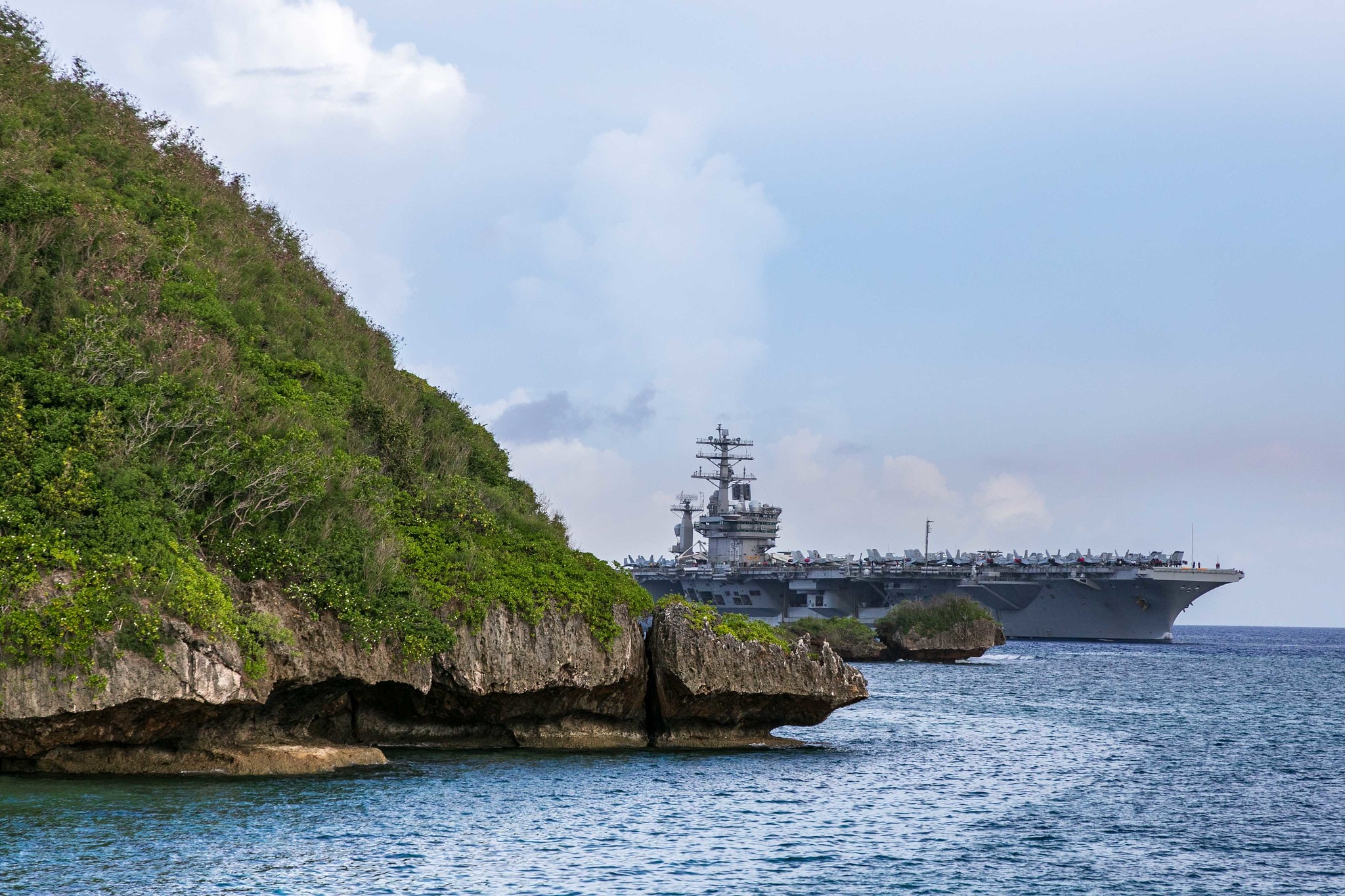 The aircraft carrier USS Nimitz (CVN 68) passes Point Udall as it enters Apra Harbor on June 24, 2020, prior to mooring at Naval Base Guam for a scheduled port visit. (Chief Mass Communication Specialist Matthew R. White/Navy)