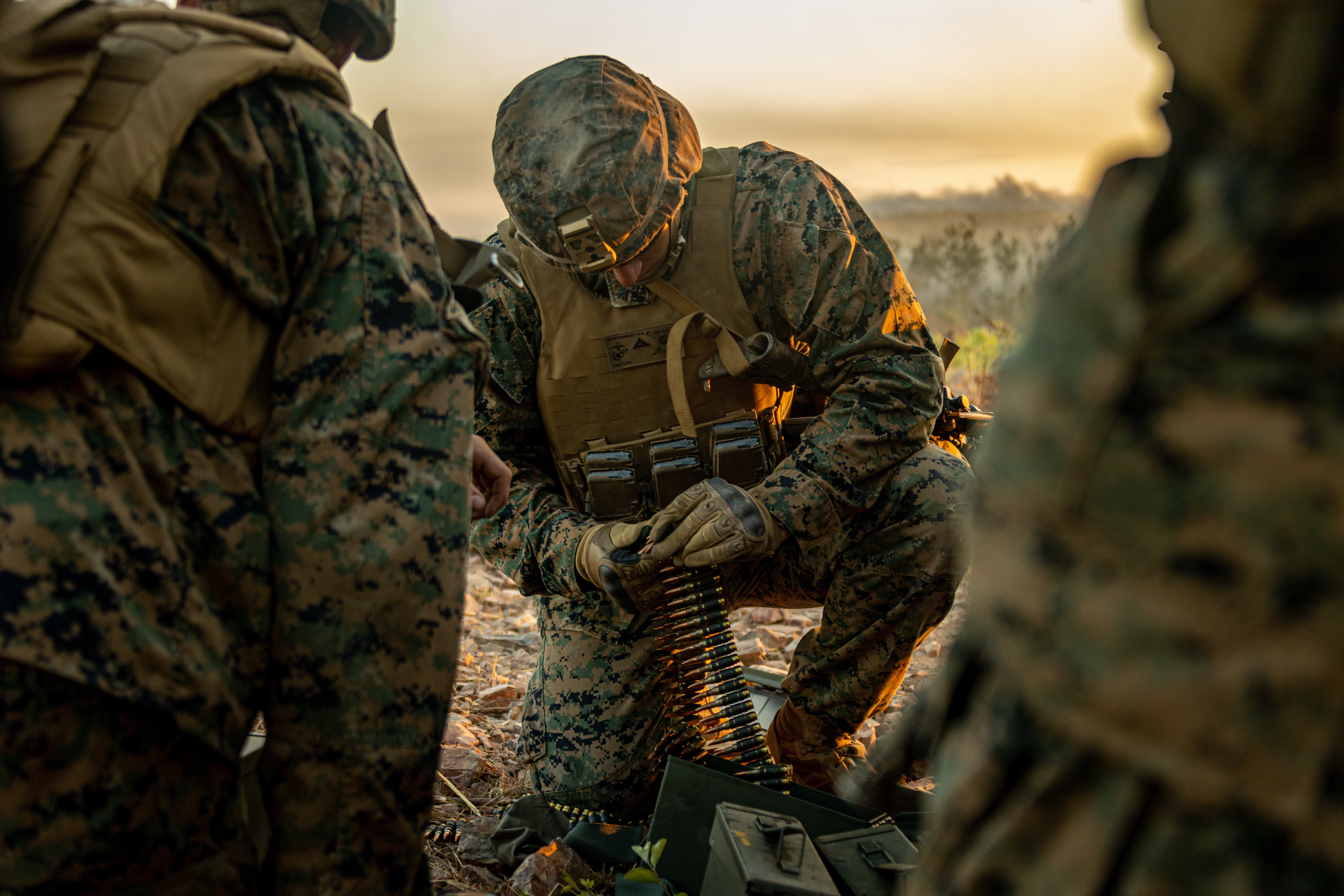 Marine Lance Cpl. Gavin Montgomery, a machine gunner in Combined Anti-armor Team Blue Platoon, with Weapons Company, 1st Battalion, 7th Marine Regiment (Reinforced), Marine Rotational Force–Darwin, prepares ammunition during exercise Southern Jackaroo at Mount Bundey Training Area, NT, Australia, June 23. (Cpl. Sarah Taggett/Marine Corps)